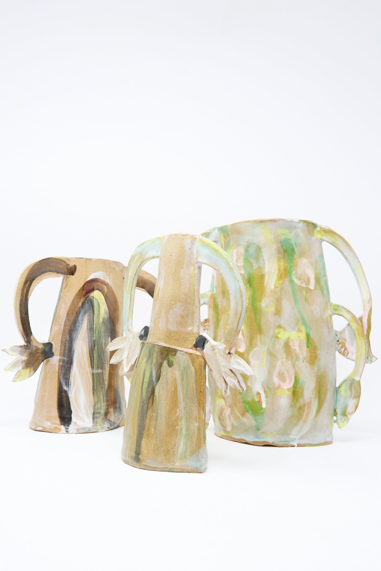 The "Two Cyclamens on Top of a Mountain Vase" by Tamar Mogendorff features hand-painted ceramic artistry, curved handles, and earthy abstract patterns, exemplifying Brooklyn's handmade vase scene against a simple white background.