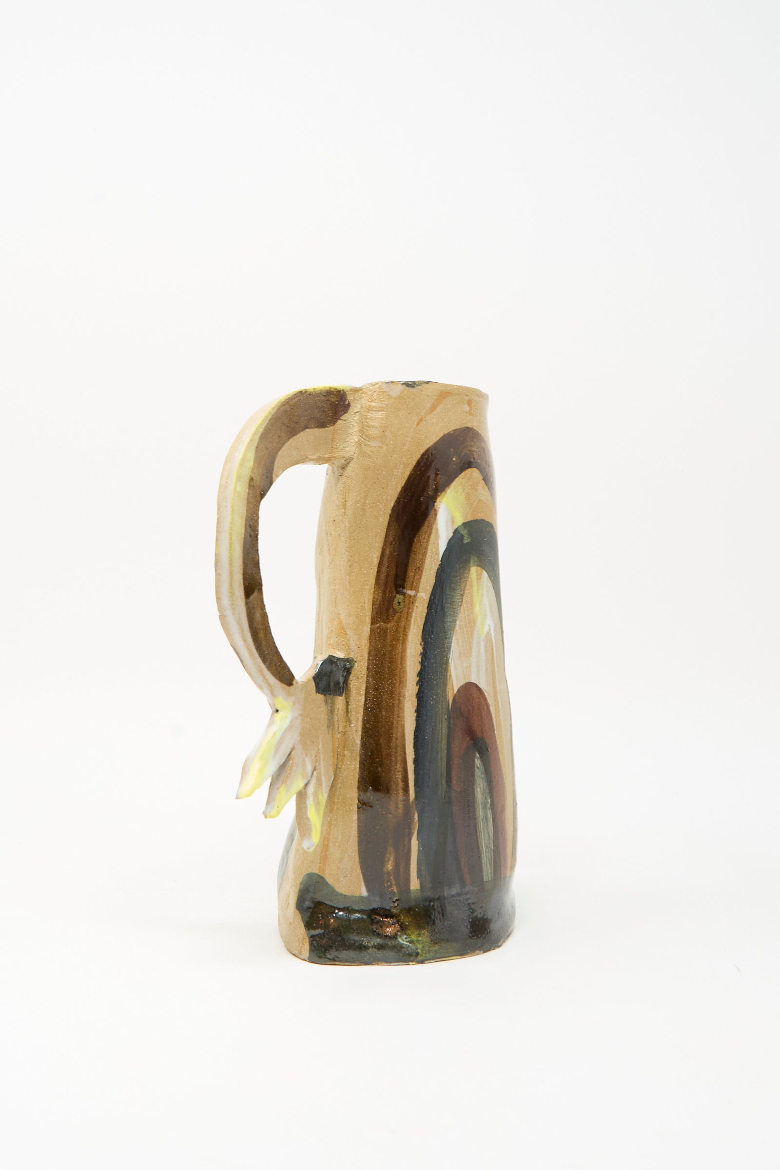 A handmade ceramic mug with an irregular shape and abstract brown, yellow, and black painted patterns on a white background, reminiscent of the unique artistry found in the "Two Cyclamens on Top of a Mountain Vase II" by Tamar Mogendorff.