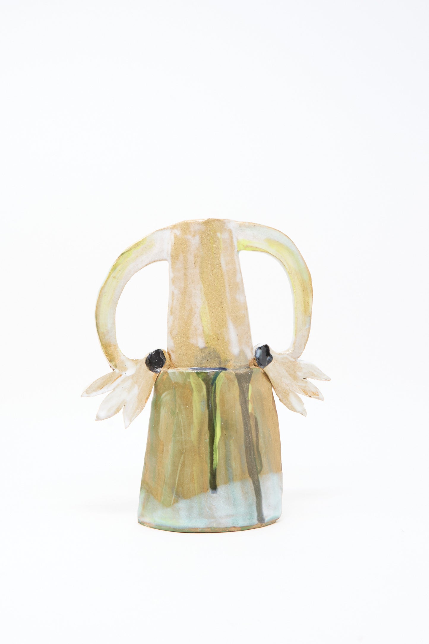 The Two Cyclamens on Top of a Mountain Vase III by Tamar Mogendorff is a handmade Brooklyn vase with two large curved handles, small floral decorations at each base, and an earthy multicolored green and blue glaze.