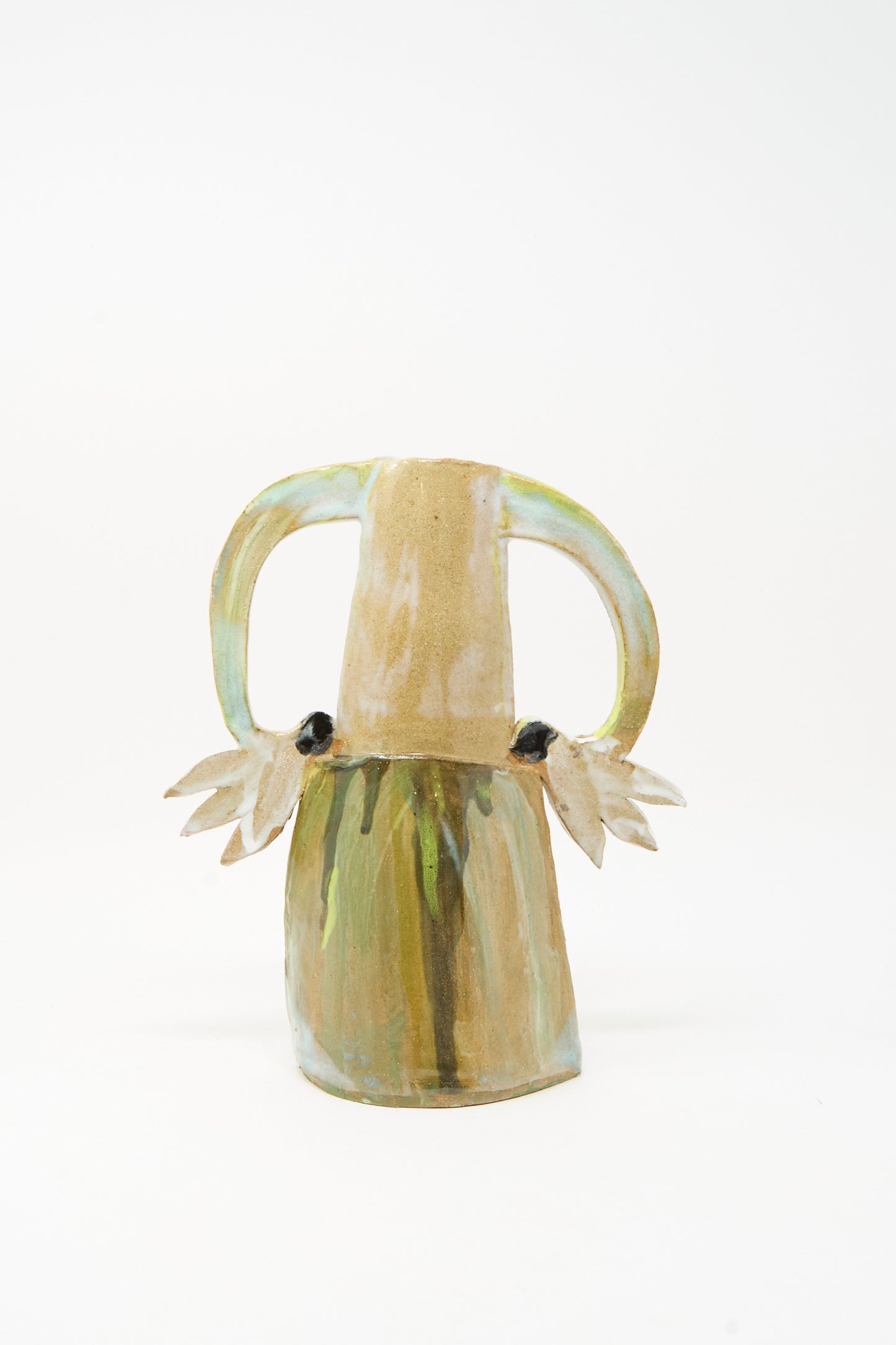 The "Two Cyclamens on Top of a Mountain Vase III" by Tamar Mogendorff is a handmade ceramic vase featuring two large handles and decorative leaf-like shapes on each side. Its earth-toned and greenish hues evoke the aesthetic of a green blue vase, presented against a plain white background.
