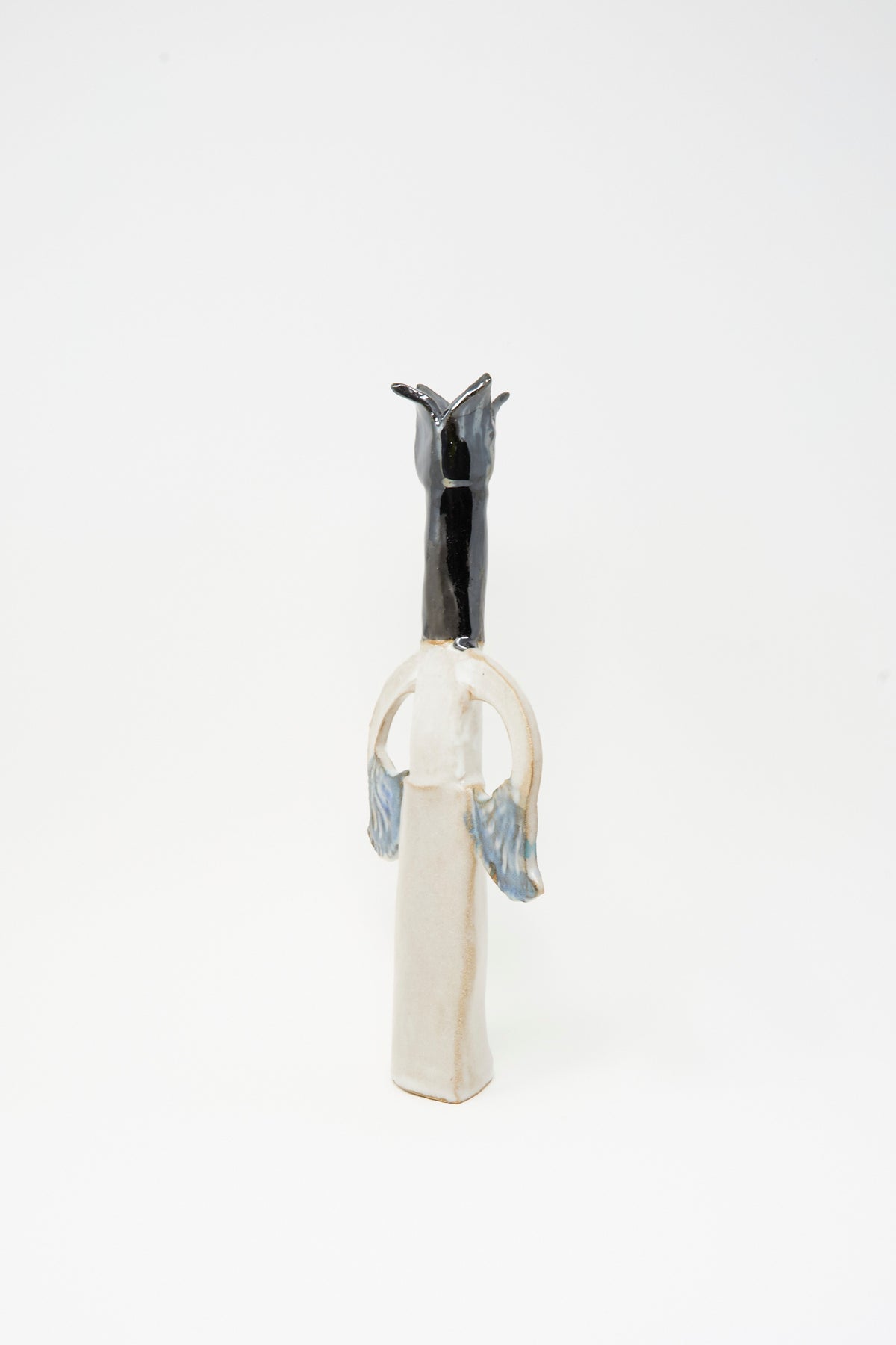 Tall, narrow Two Papyrus Candle Holder by Tamar Mogendorff, shaped like a stylized figure with a black head and blue-accented arms featuring a multicolored glaze.