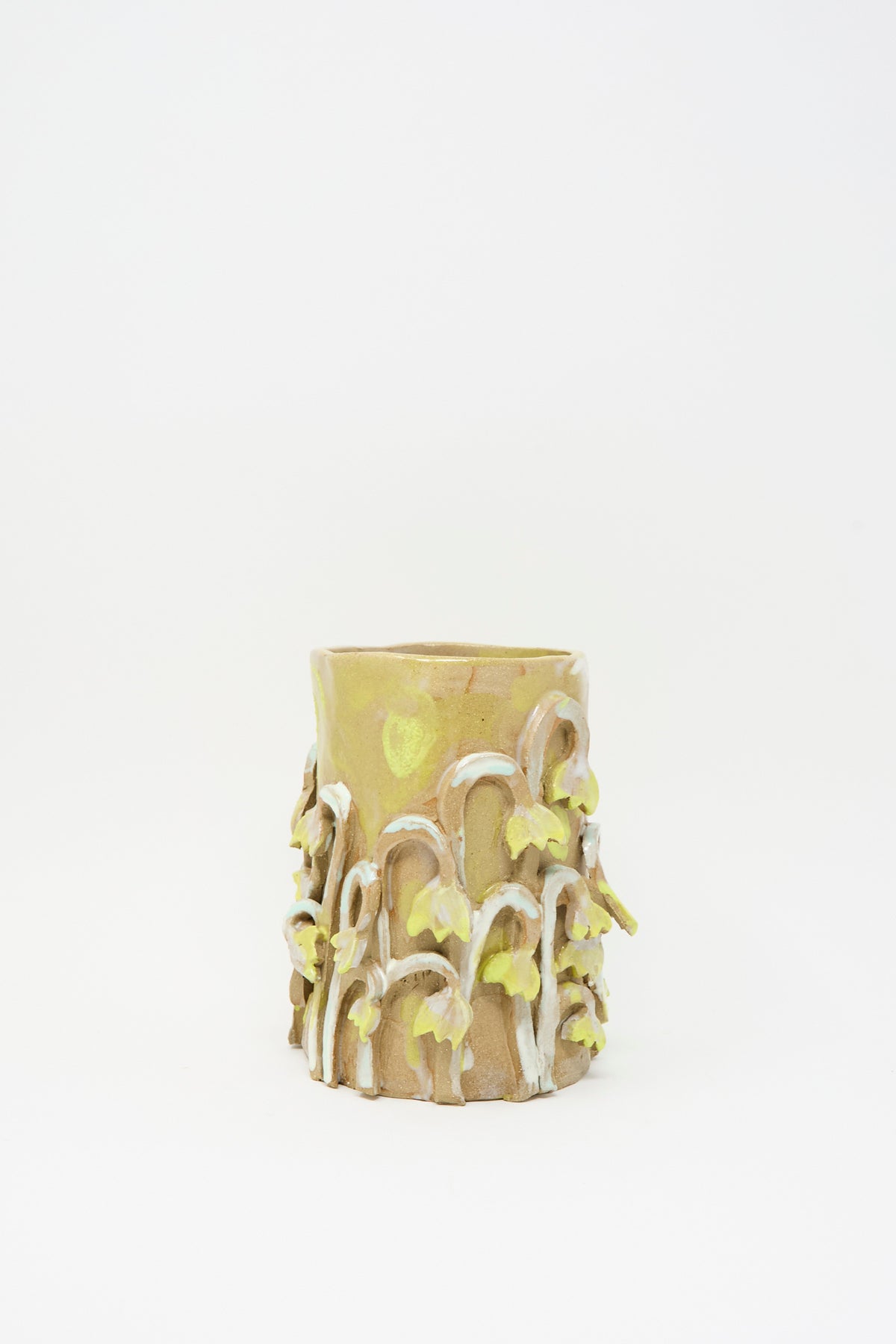 Tamar Mogendorff Yellow Fritillaria Vase, a cylindrical yellow ceramic vessel decorated with sculpted fritillaria flowers and stems.