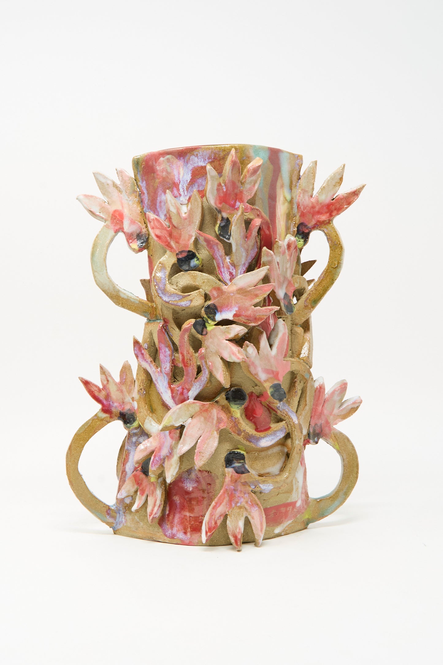 The Cyclamens in the Wild Vase by Tamar Mogendorff is a handmade ceramic piece featuring pink, red, and cream floral decorations with winding stems set against a plain white background.