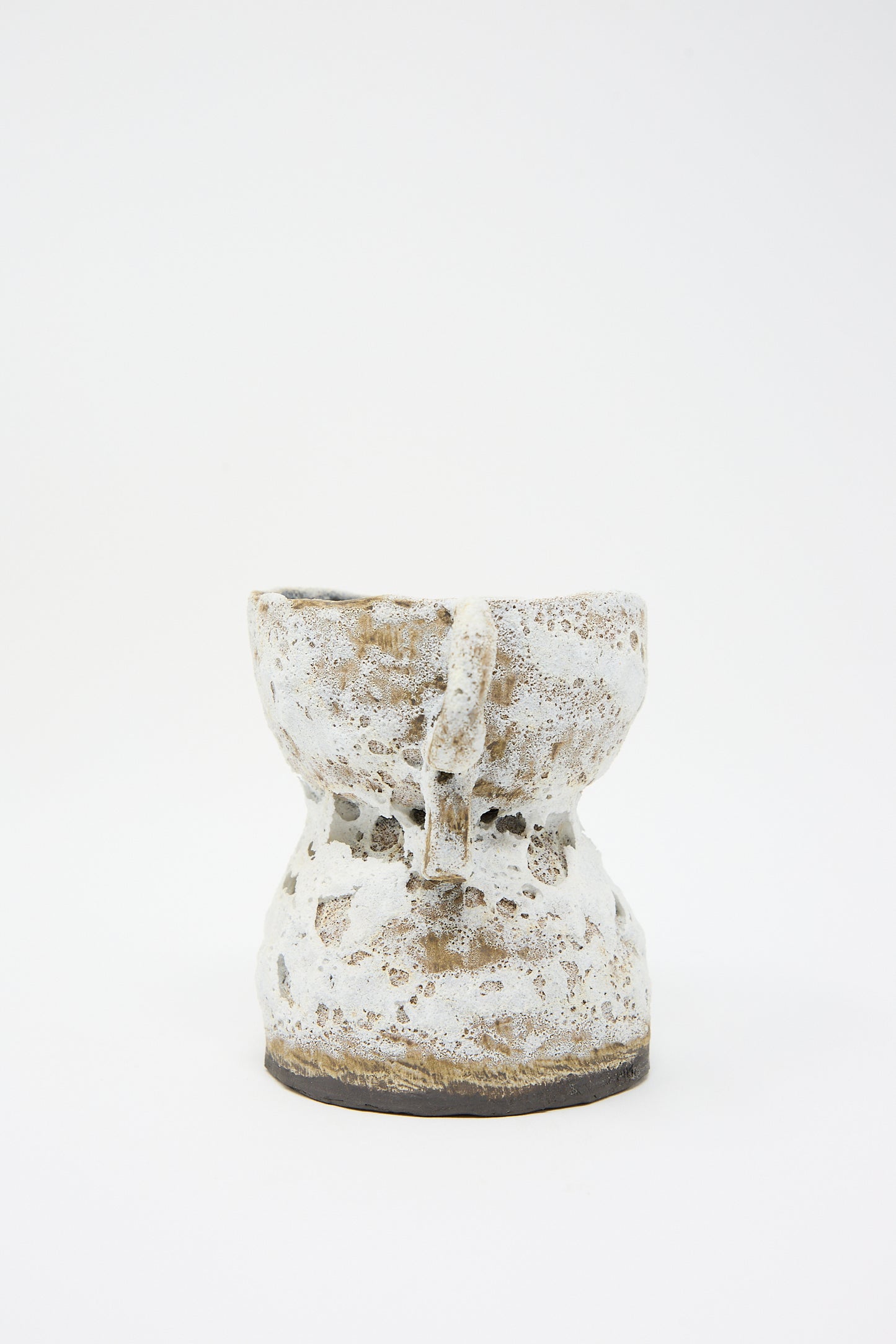 A white, hand-built vase with a narrow base and wide, irregularly shaped opening, displayed on a plain white background. The Ancient One Vase by Tania Whalen.