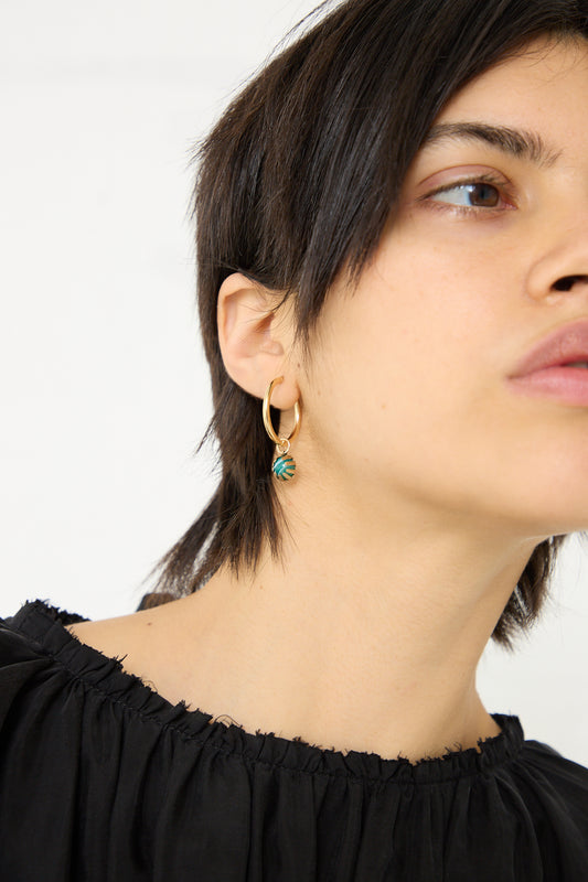 A woman wearing the Tara Turner Single Green Stripe Agate Claw Earring.
