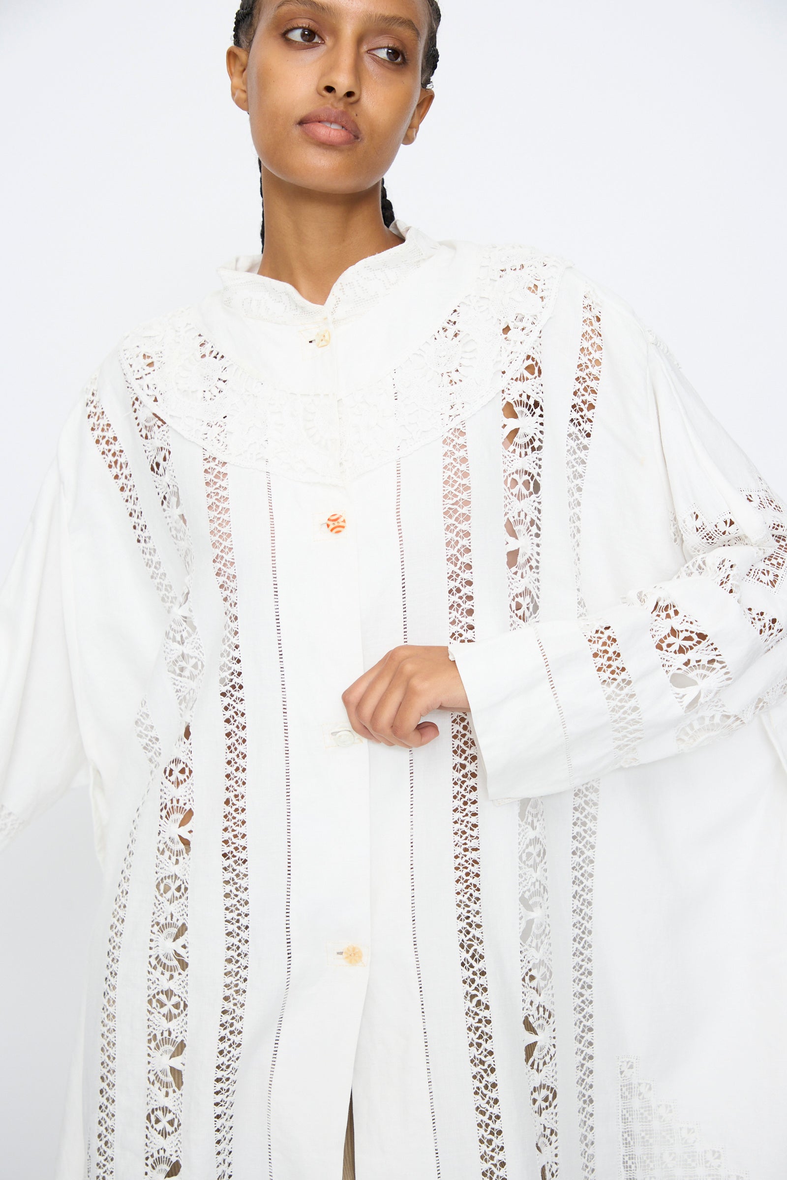 A person wearing the Ruffle Oversized Oxford shirt by Thank You Have A Good Day, featuring lace and crochet details, stands against a plain white background.