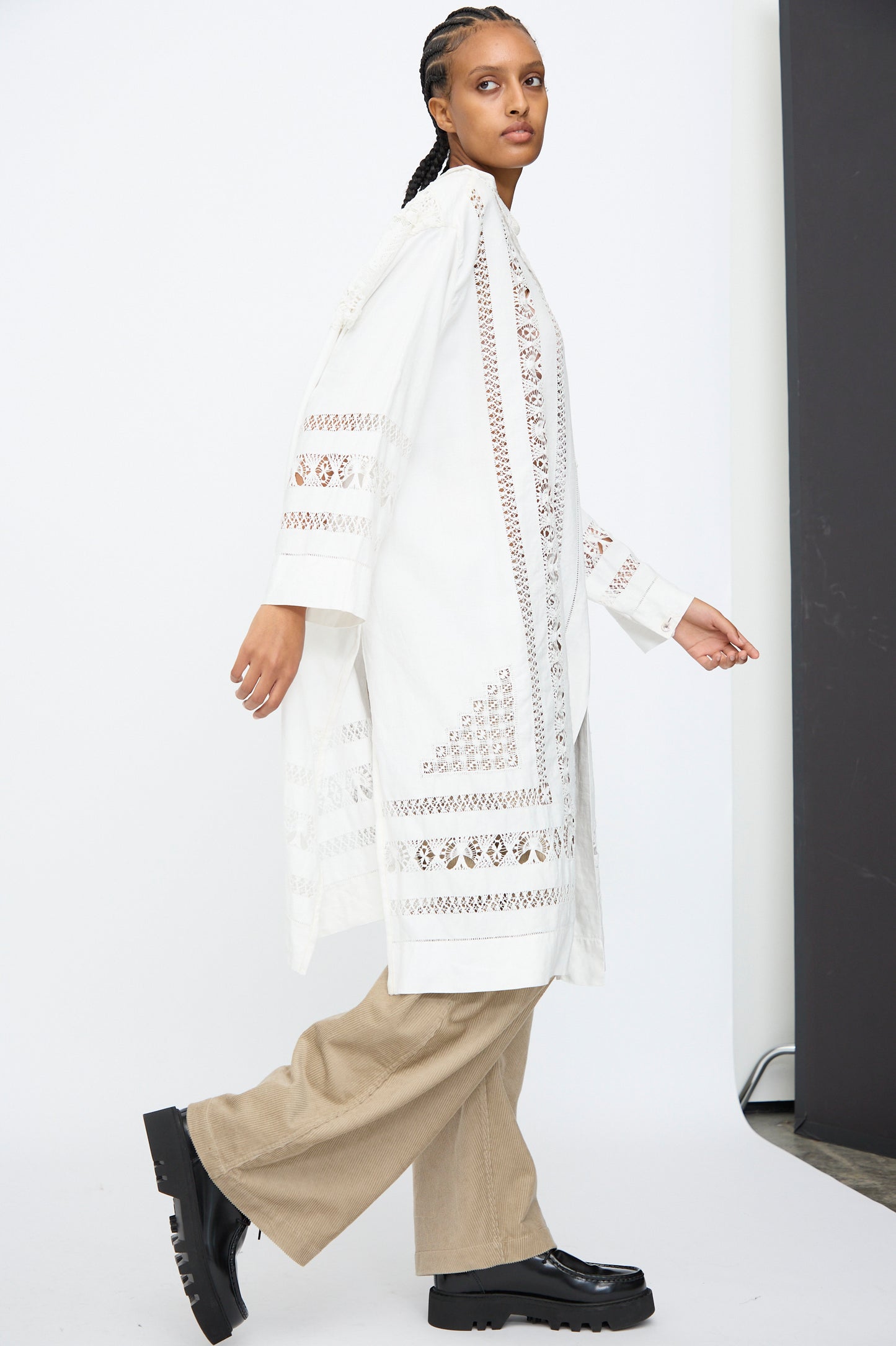 A person wears the Thank You Have A Good Day Ruffle Oversized Oxford, paired with beige wide-leg pants and black platform shoes, standing against a white background.