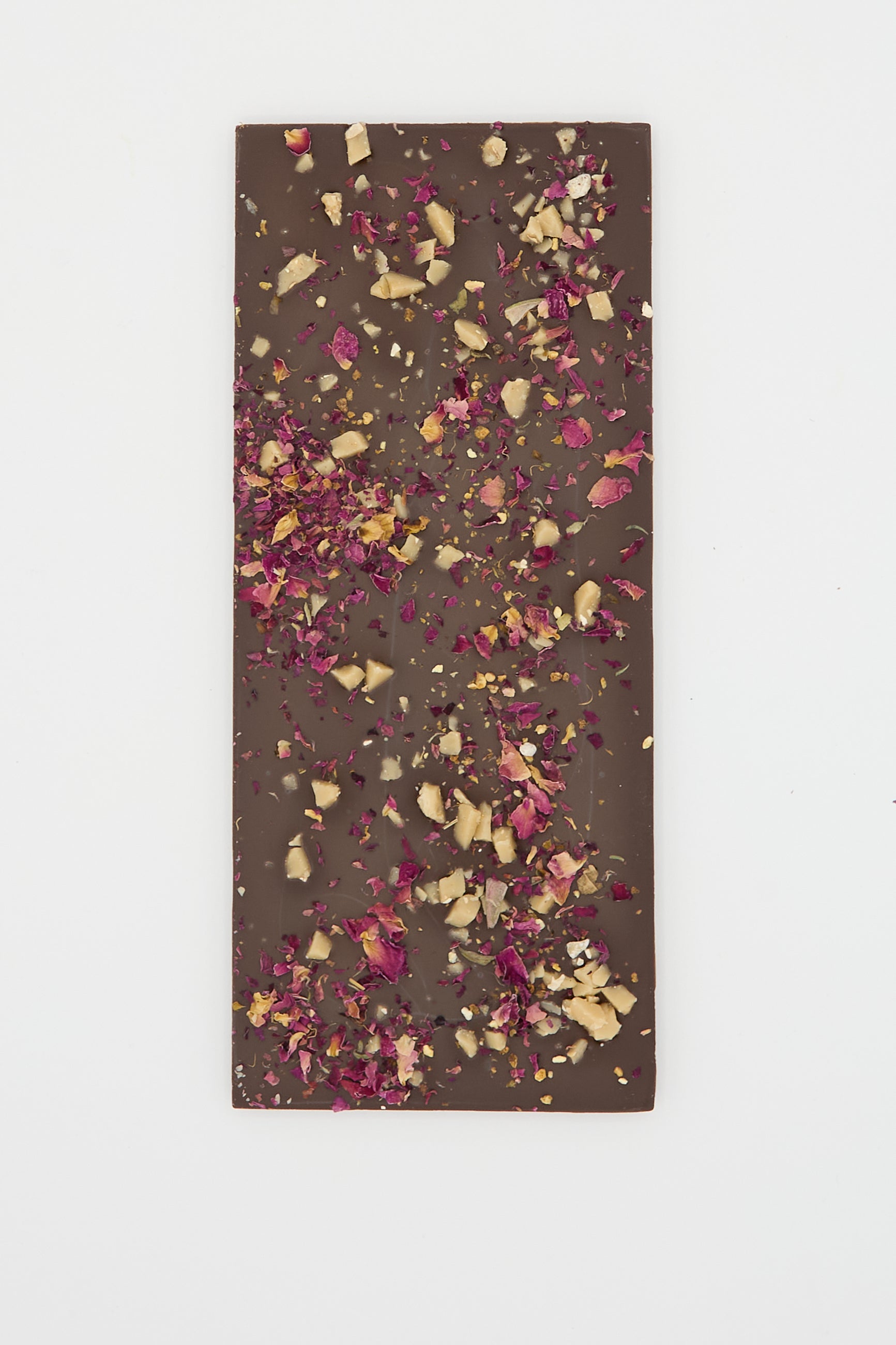 A Botanical Wonder Bar from The Quiet Botanist, featuring a rectangular botanical dark chocolate bar adorned with dried rose petals and chopped nuts, set against a plain white background.