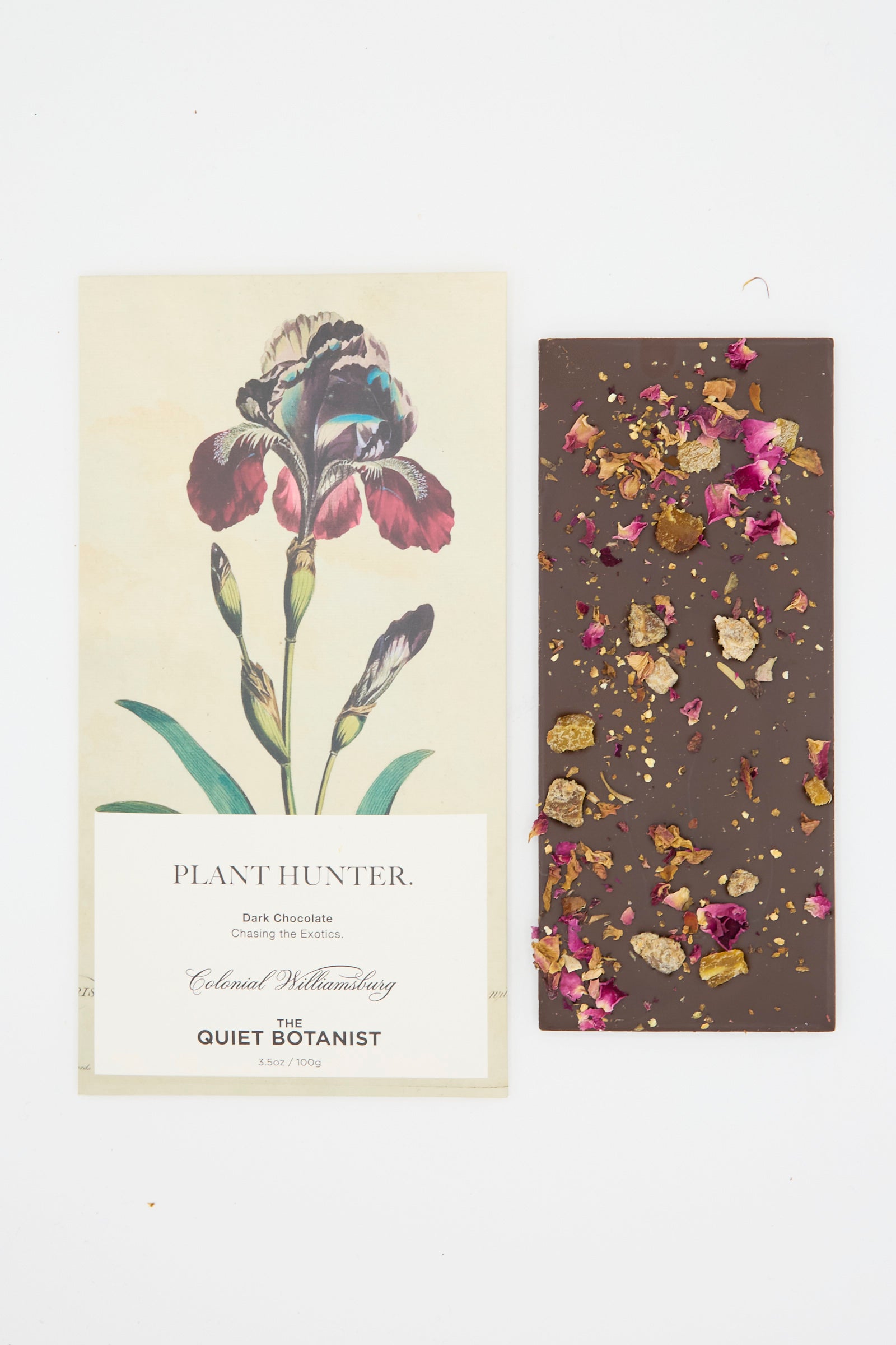 The Plant Hunter Bar by The Quiet Botanist, crafted with organic ingredients and botanical floral pieces, sits alongside a "Plant Hunter" label adorned with an iris illustration from the Colonial Williamsburg collection.