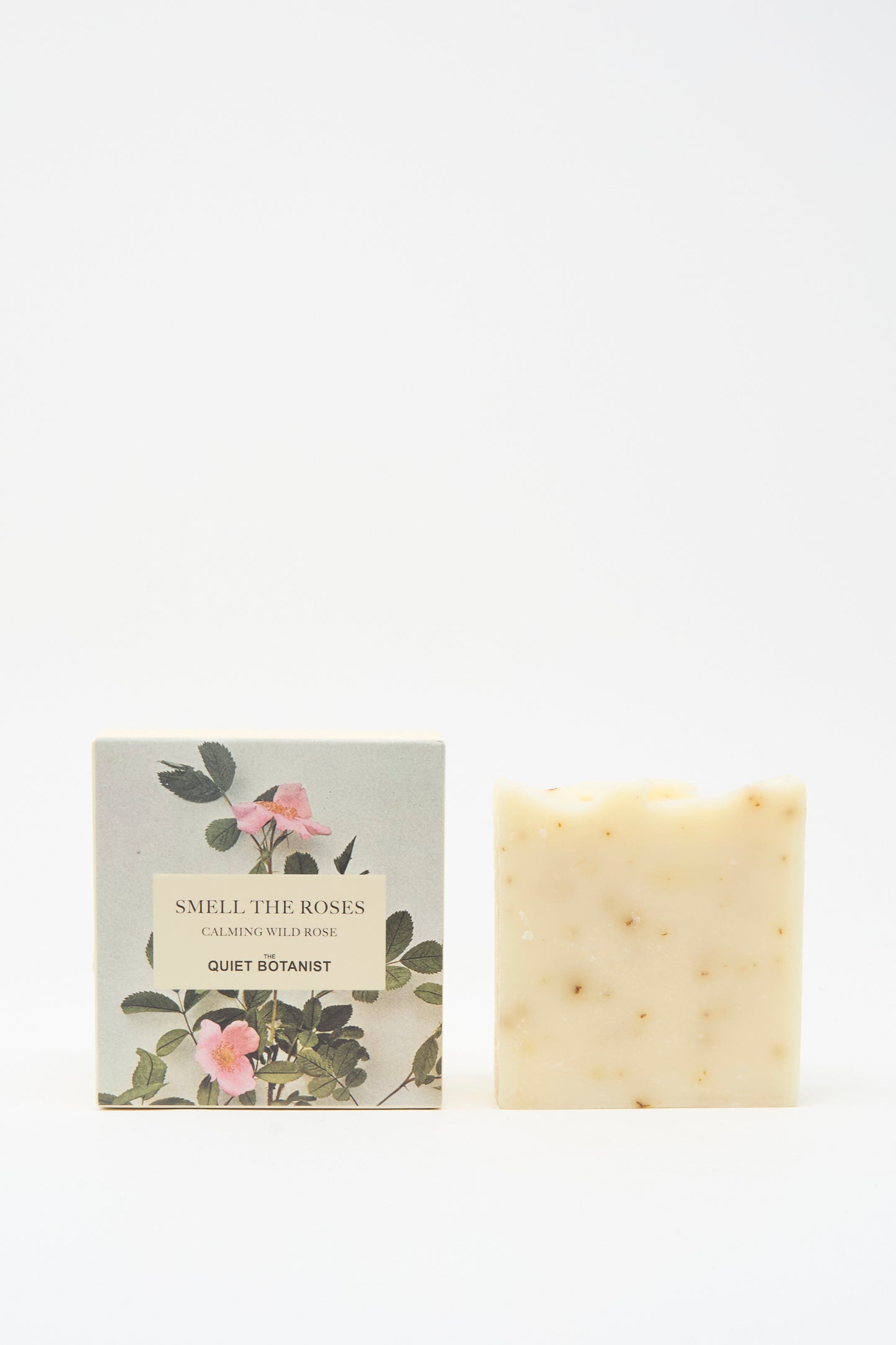 A vegan Smell The Roses Soap Bar by The Quiet Botanist stands beside its floral box, which hints at the artisanal Turkish craftsmanship within.