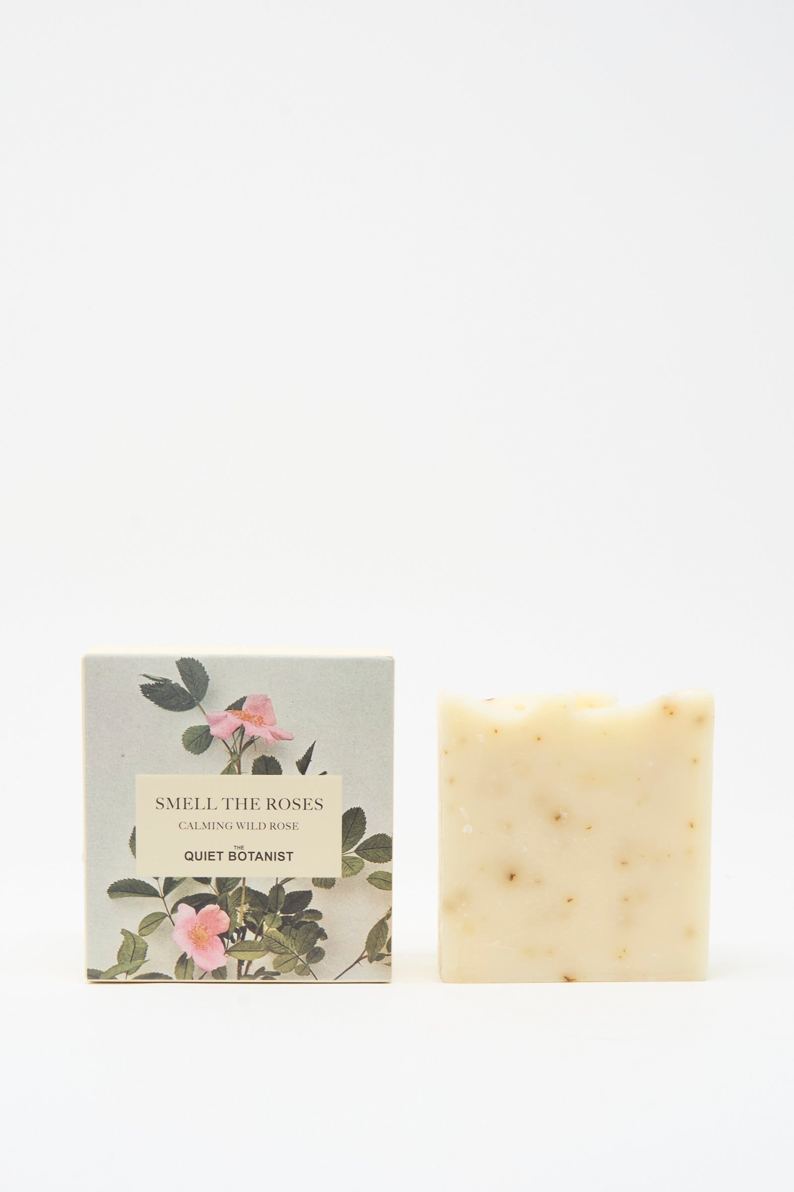 A vegan Smell The Roses Soap Bar by The Quiet Botanist stands beside its floral box, which hints at the artisanal Turkish craftsmanship within.