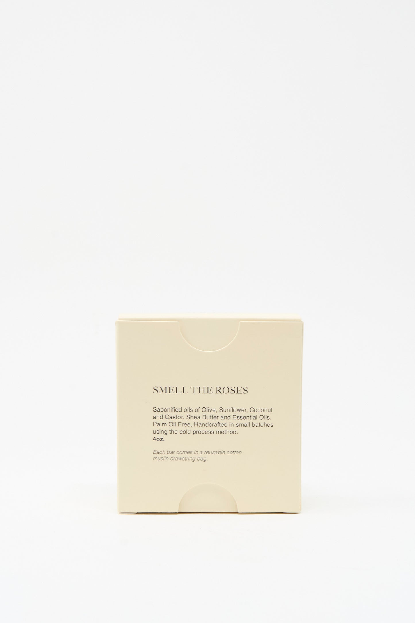 A beige box labeled "Smell The Roses Soap Bar" by The Quiet Botanist, showing product details and ingredients on the front, contains a vegan rose bar soap handmade in Turkey, set against a plain white background.