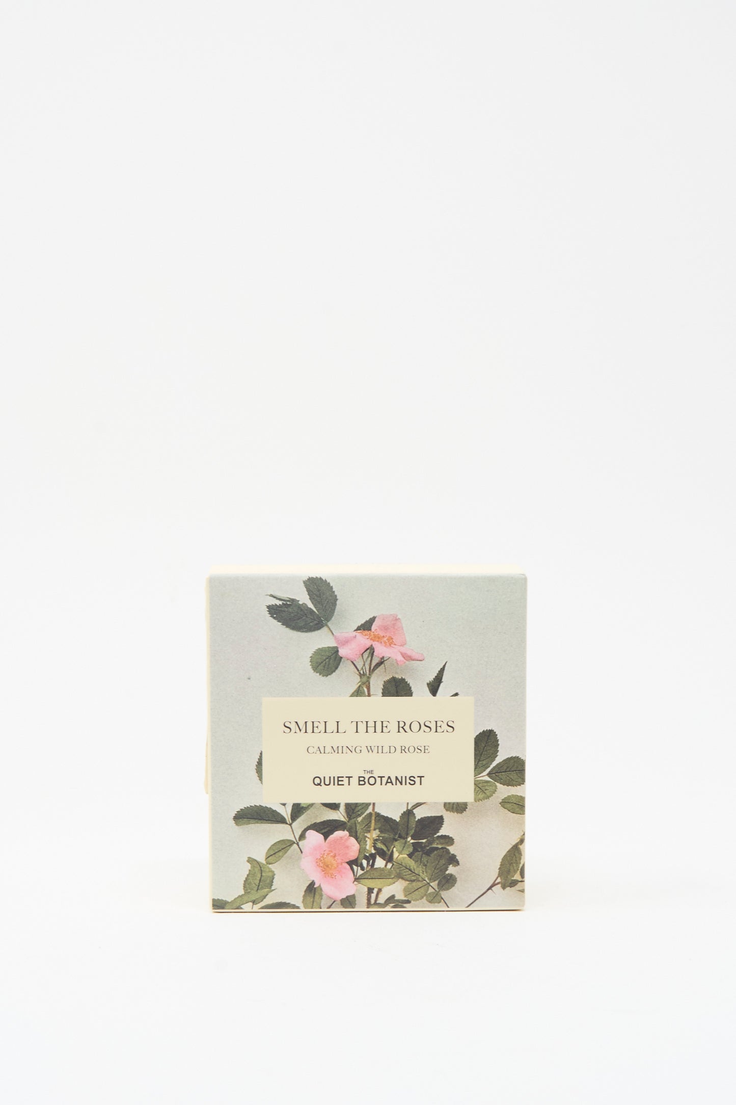 A box labeled "Smell The Roses Soap Bar" by The Quiet Botanist displays pink wild roses and green leaves on a light background. This vegan soap is handmade in Turkey.
