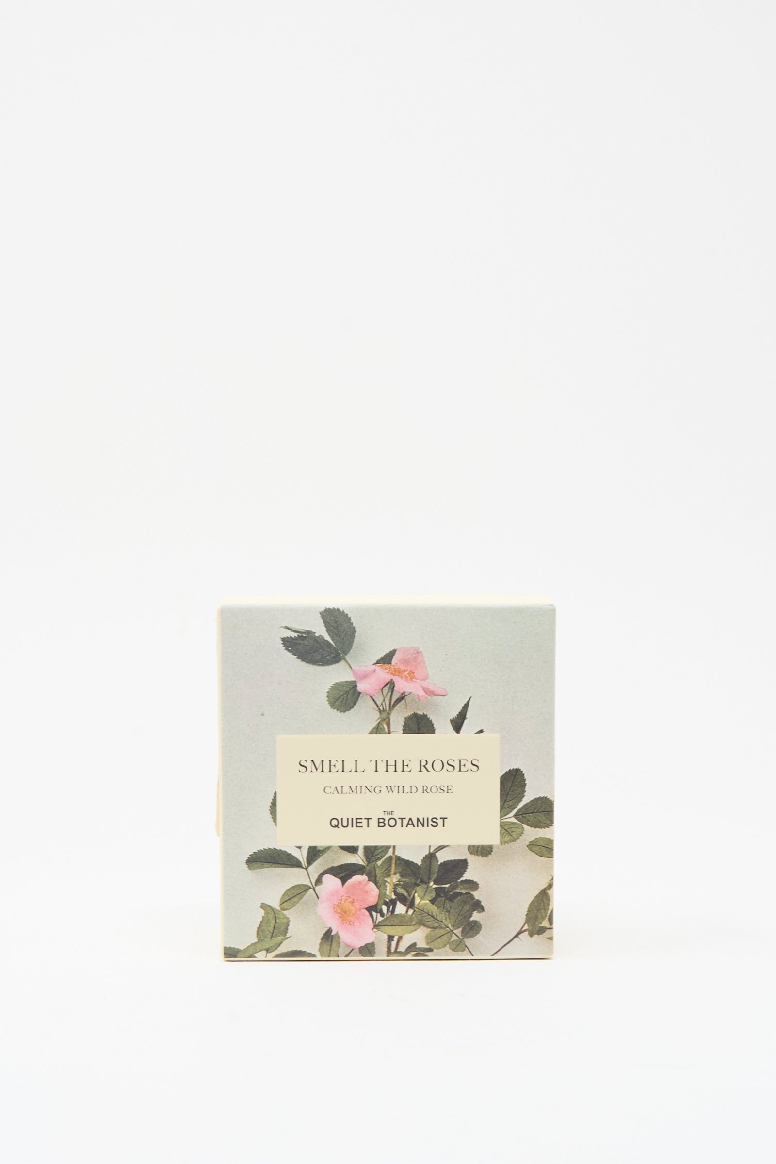 A box labeled "Smell The Roses Soap Bar" by The Quiet Botanist displays pink wild roses and green leaves on a light background. This vegan soap is handmade in Turkey.