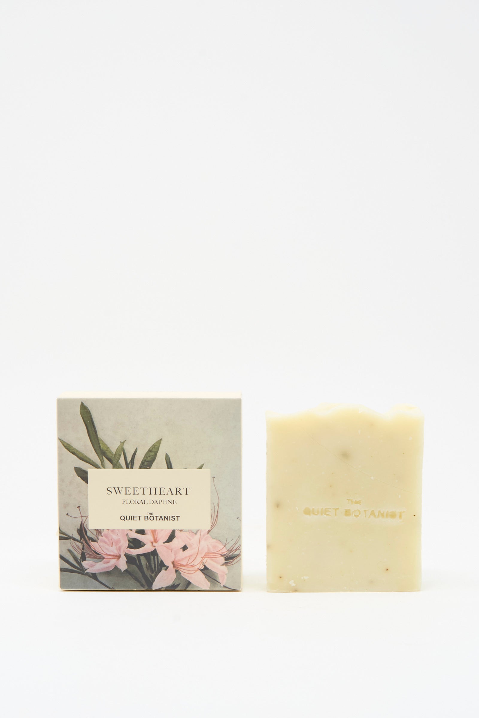 The Quiet Botanist Sweetheart Floral Daphne Soap Bar, handmade in Turkey for sensitive skin, sits by its floral-illustrated box labeled "Sweetheart Floral Botanical.