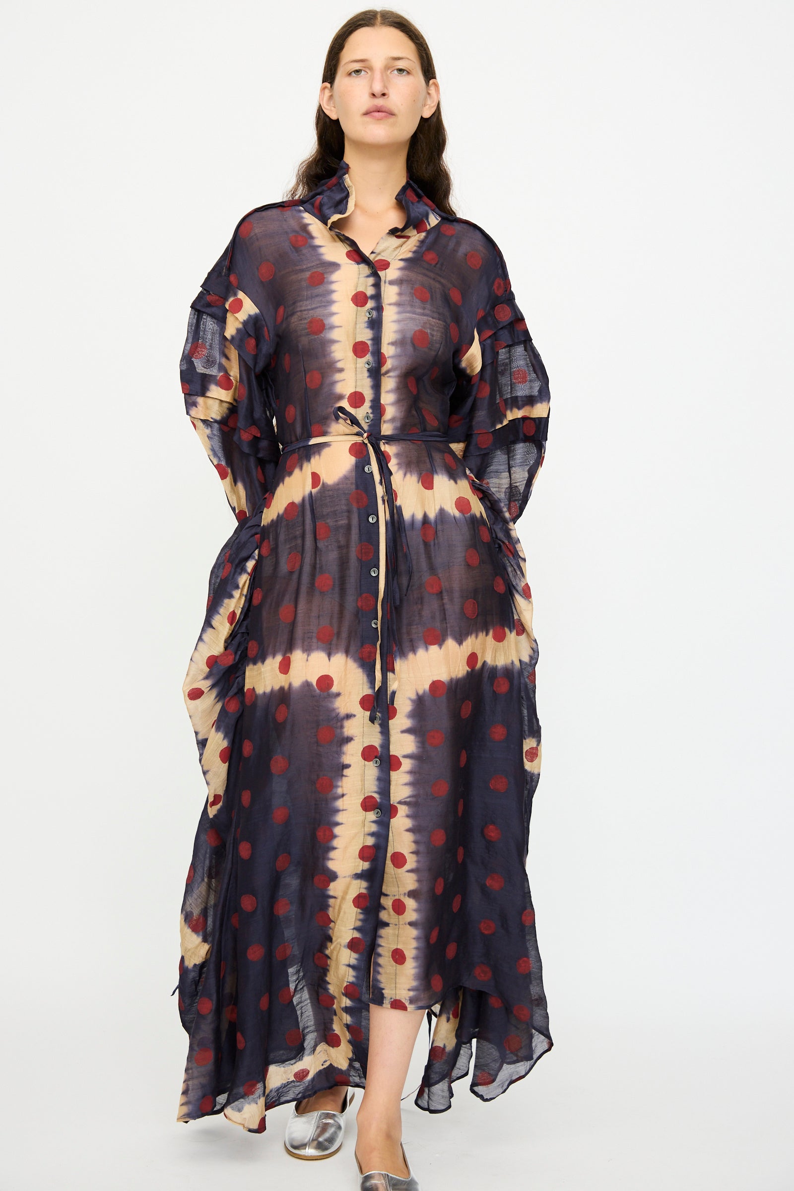 A woman wears the TIGRA TIGRA Silk Chanderi Teatime Dress in Navy, Cream, and Red, featuring a tie waist. She stands against a plain white background.