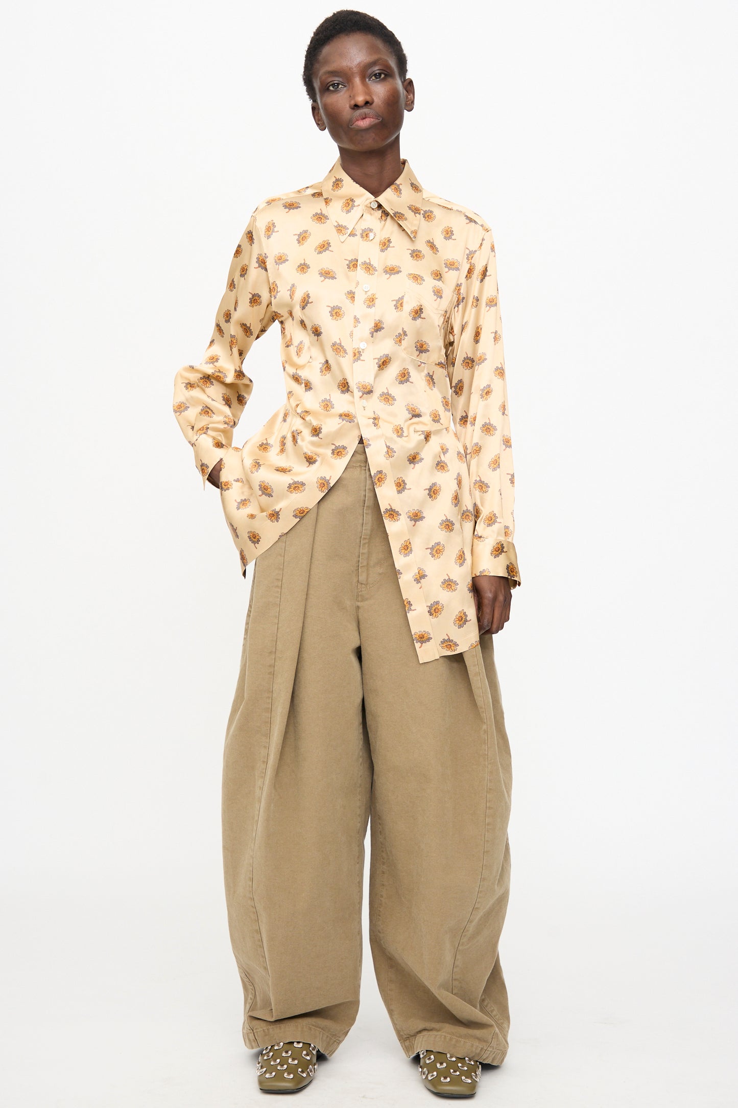 Model wears the TOGA ARCHIVES Flower Print Shirt in Beige with wide-leg khaki pants, standing against a plain white background.