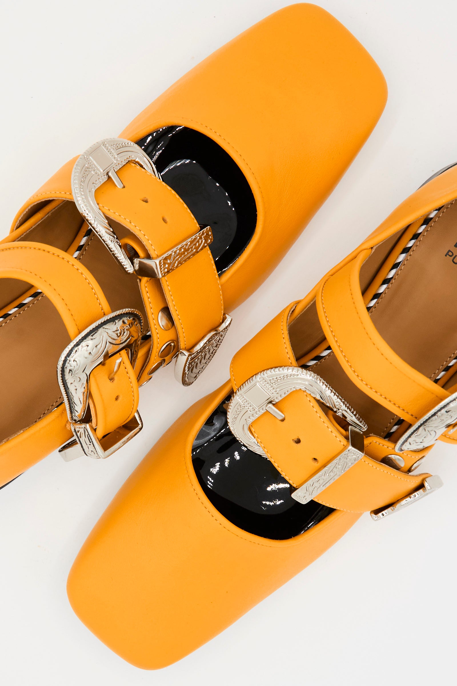 Close-up of TOGA ARCHIVES Leather Flat in Orange, featuring square toes, wide pin-buckle straps, and large ornate silver buckles, displayed on a white background.