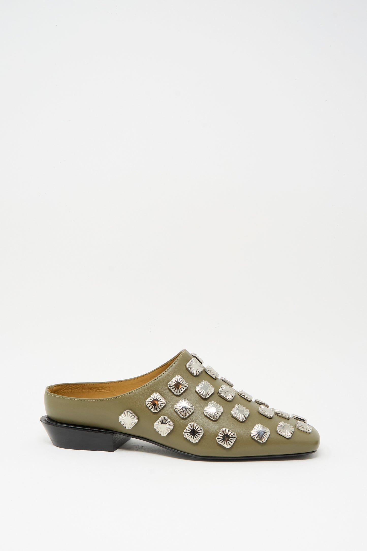 The TOGA ARCHIVES Leather Mule in Khaki features a square toe, low black heel, and bold silver hardware—multiple round studs accent the upper for a chic finish.