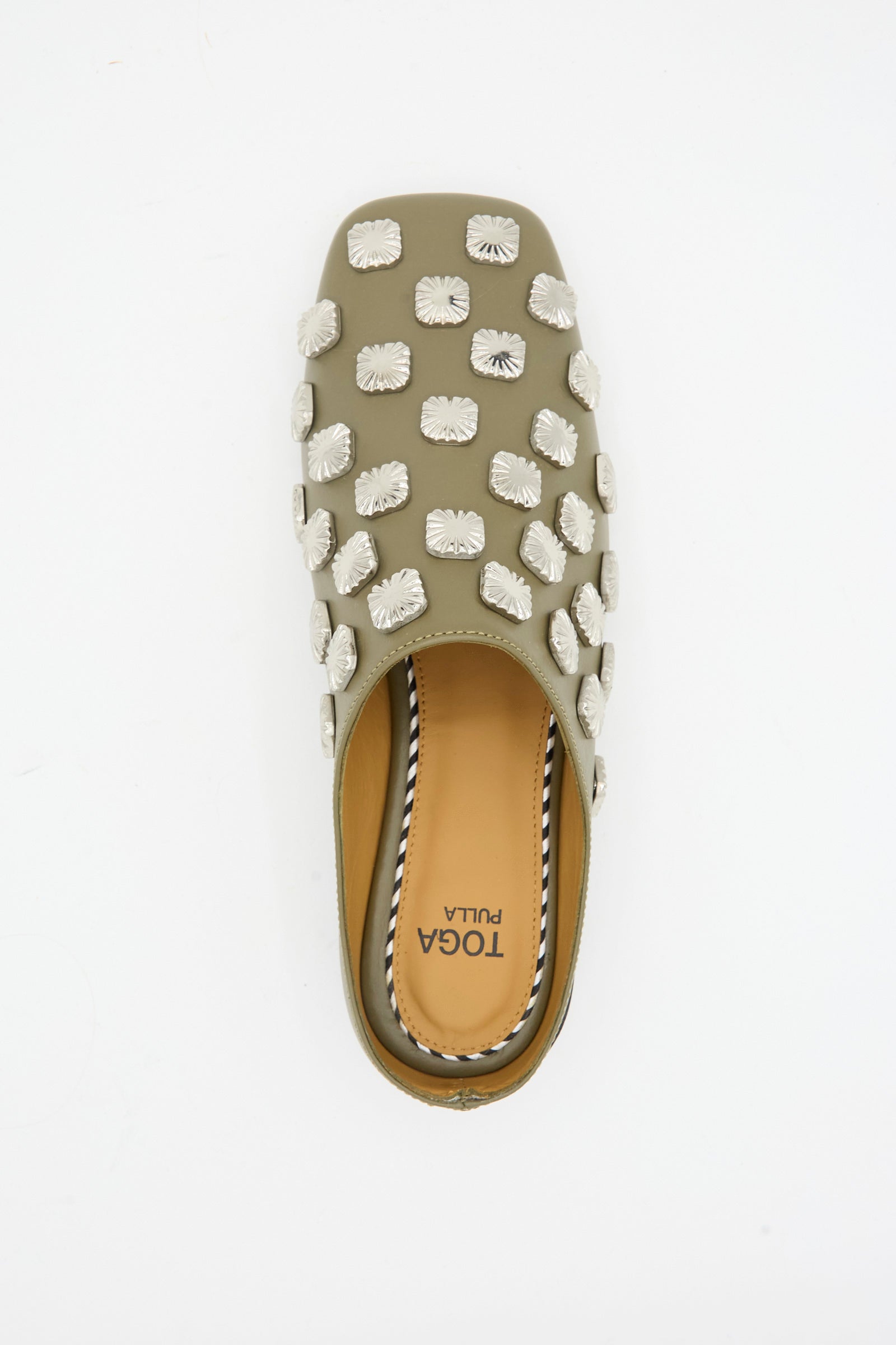 A top view of the Leather Mule in Khaki by TOGA ARCHIVES, featuring a square toe, multiple white floral embellishments, and a tan insole branded with "TOGA PULLA".