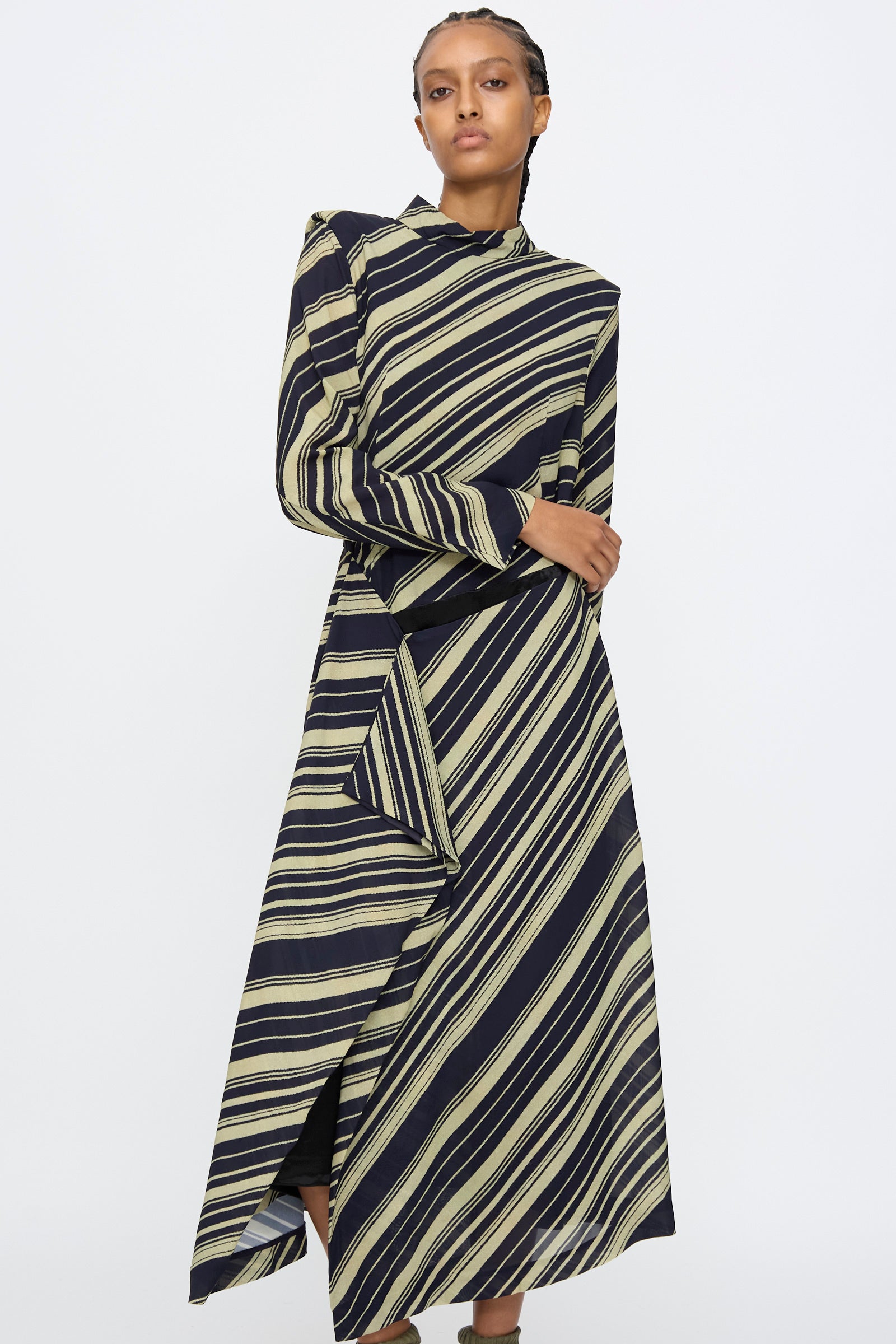 A person wearing the TOGA ARCHIVES Rayon Print Dress in Navy stands against a plain white background.