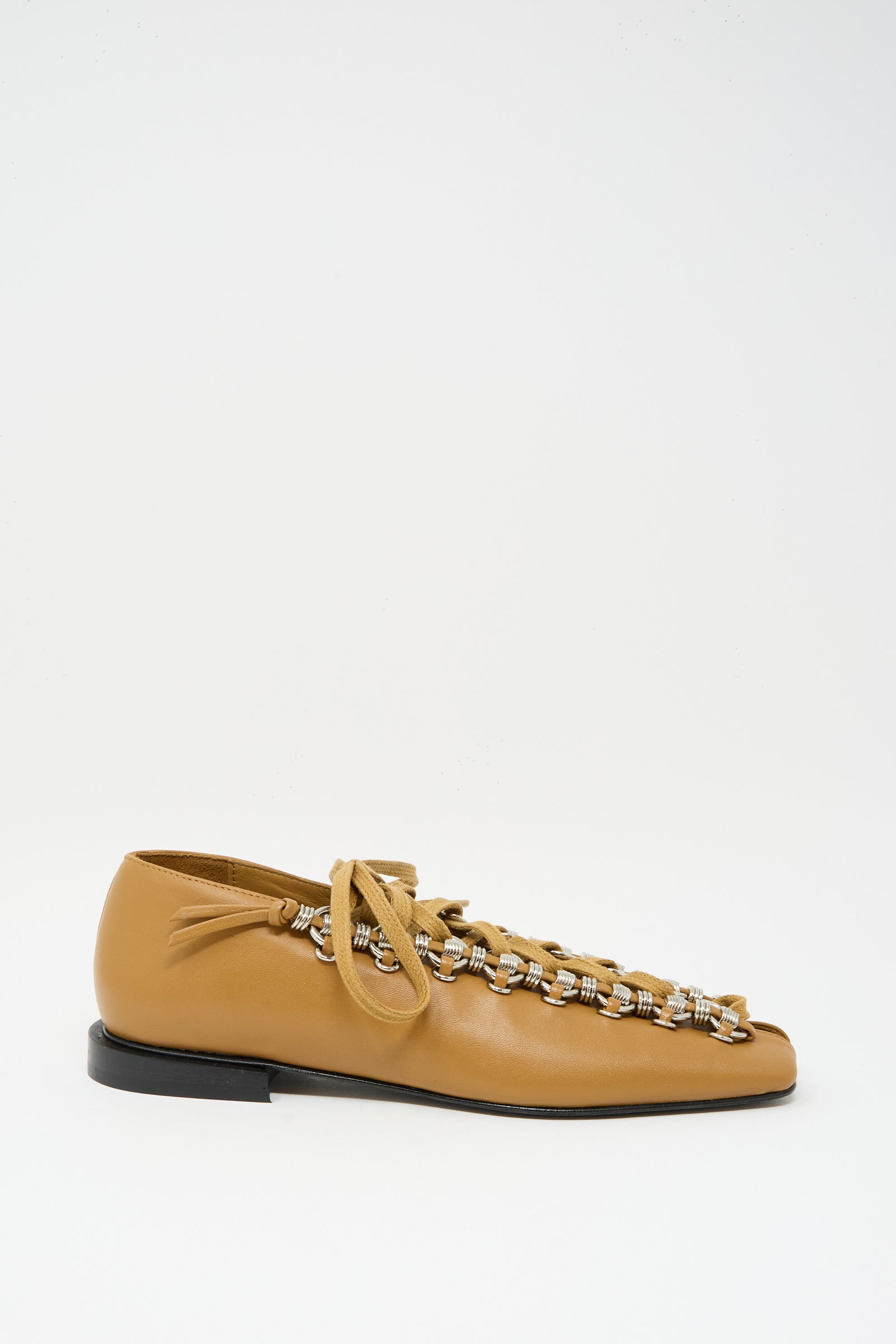 The TOGA ARCHIVES Soft Leather Shoe in Tan is a single lace-up with tan cowhide leather, plaid woven detailing, tan laces, and a black sole. Displayed on a white background. Made in Portugal.