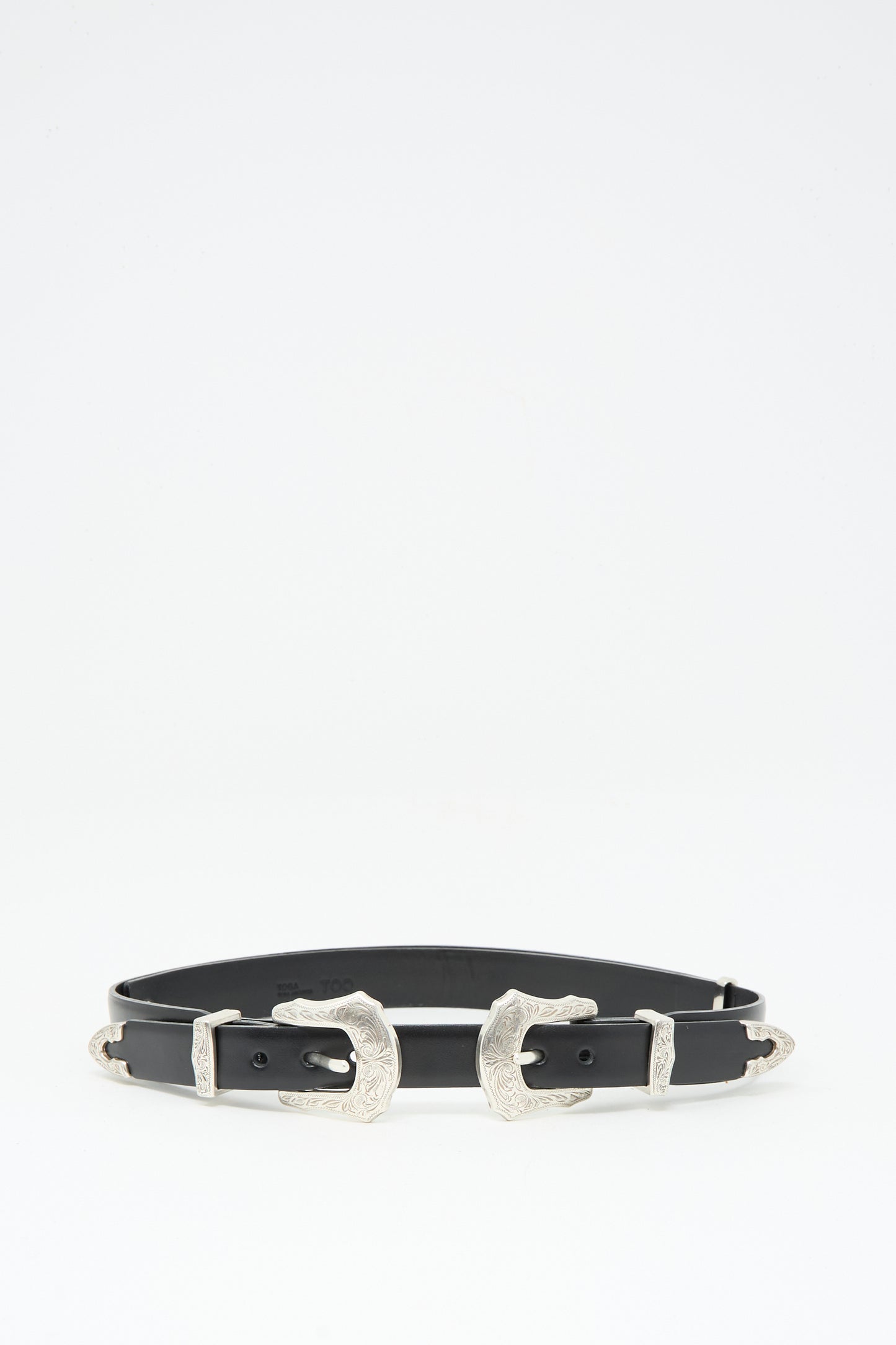 The TOGA ARCHIVES Double Buckle Belt in Black is crafted from black cowhide leather with two engraved silver buckles and matching tips, shown against a plain white background.