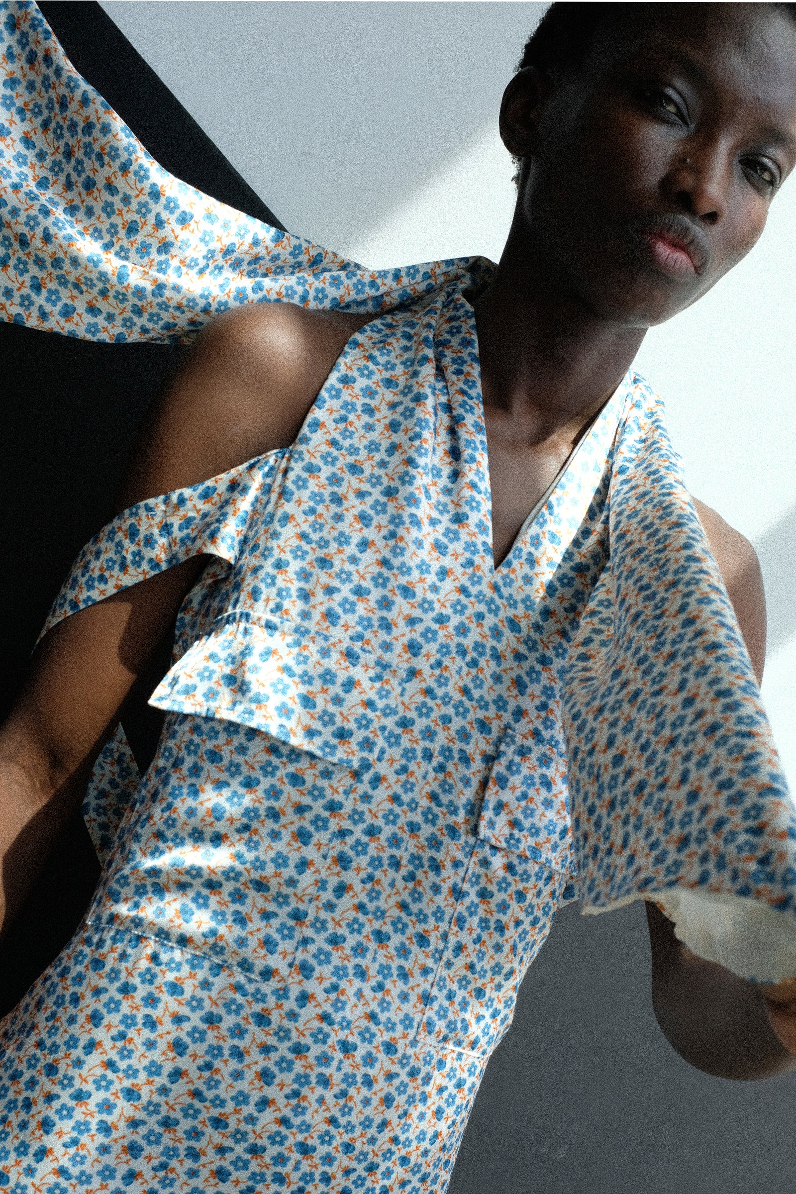 Person wearing the Toga Archives Flower Print Dress in White against a neutral background