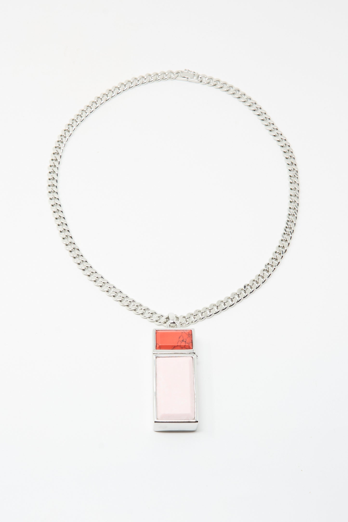 The TOGA ARCHIVES Pill Case Necklace in Light Pink is a silver chain necklace with a pill case pendant featuring a large pale pink section and a smaller red top, made in Japan. Shown on a white background.