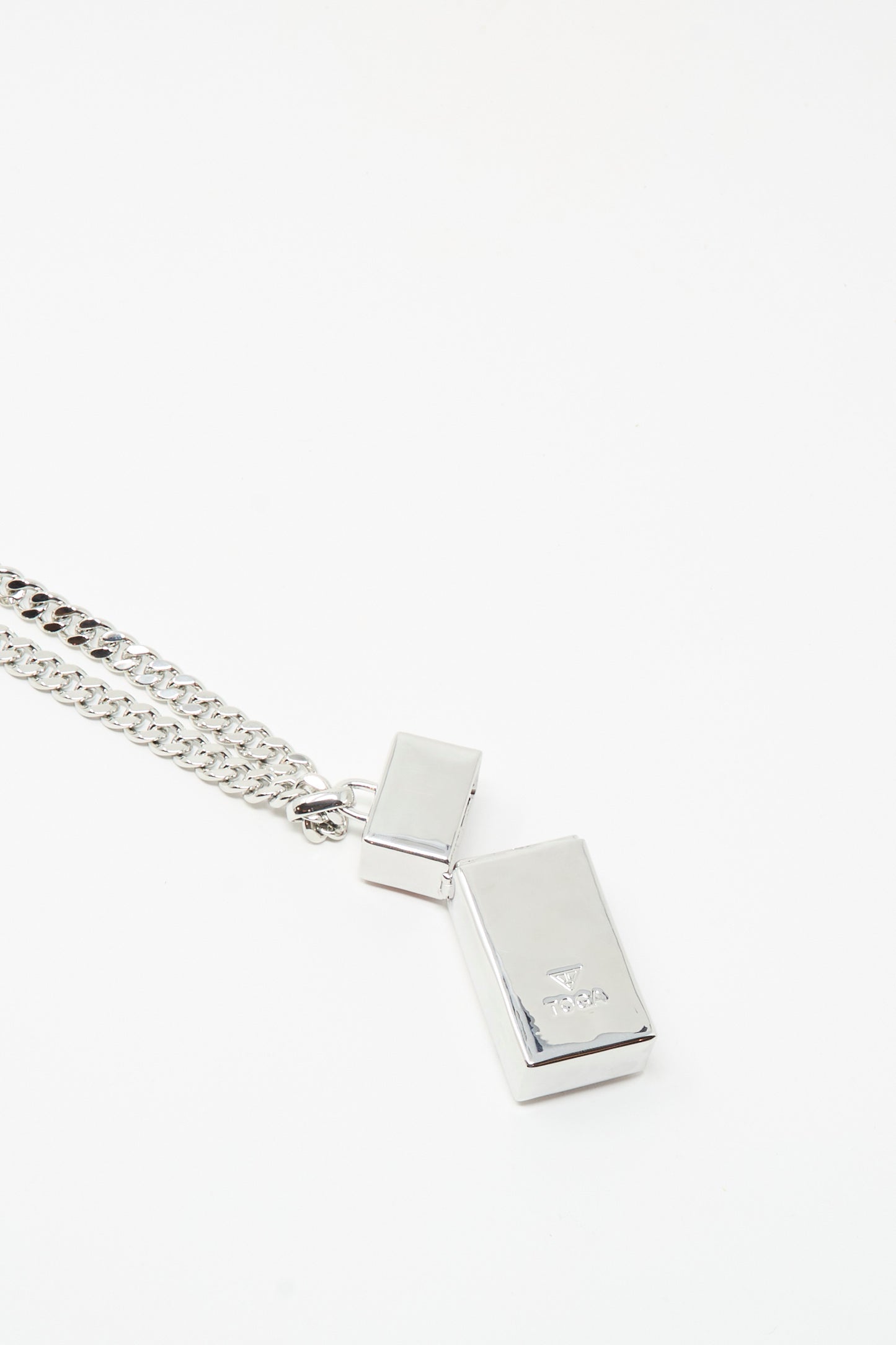 The TOGA ARCHIVES Pill Case Necklace in Light Pink features a silver chain with two rectangular pendants—one larger pill case pendant and one smaller—displayed on a plain white background.