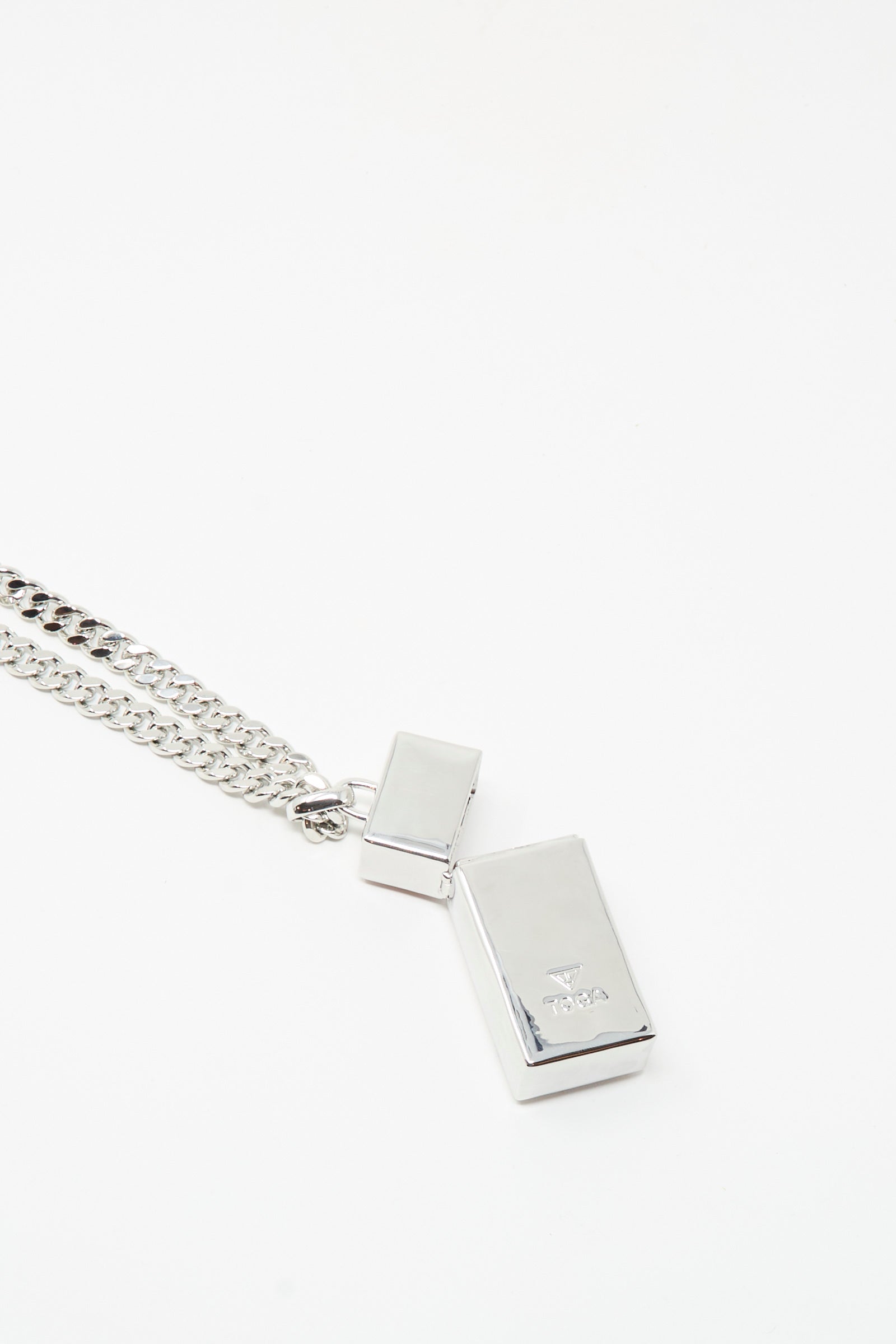 The TOGA ARCHIVES Pill Case Necklace in Light Pink features a silver chain with two rectangular pendants—one larger pill case pendant and one smaller—displayed on a plain white background.