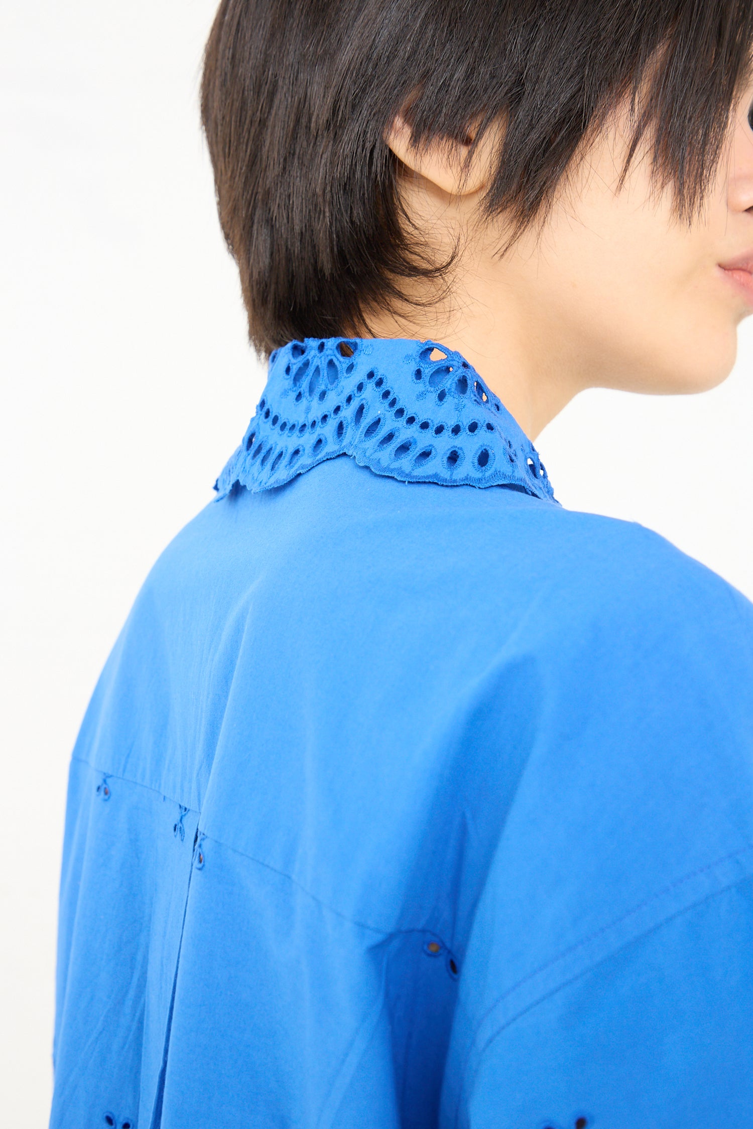 Close-up of a person wearing an Ulla Johnson Adette Dress in Cobalt with a detailed collar.