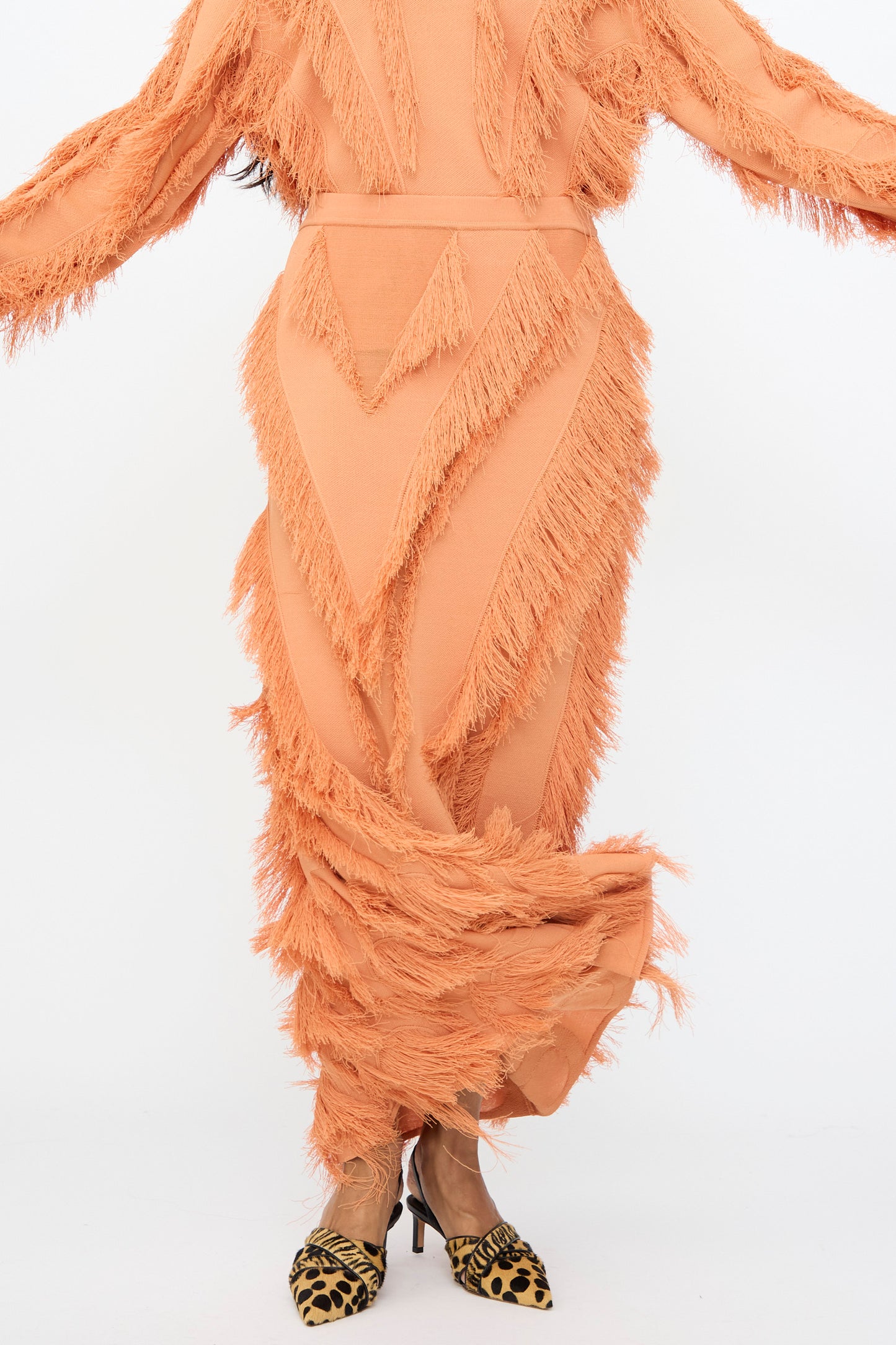 Model wearing the Astrid Maxi Skirt in Tulip by Ulla Johnson, arms partially outstretched, standing against a plain white background.