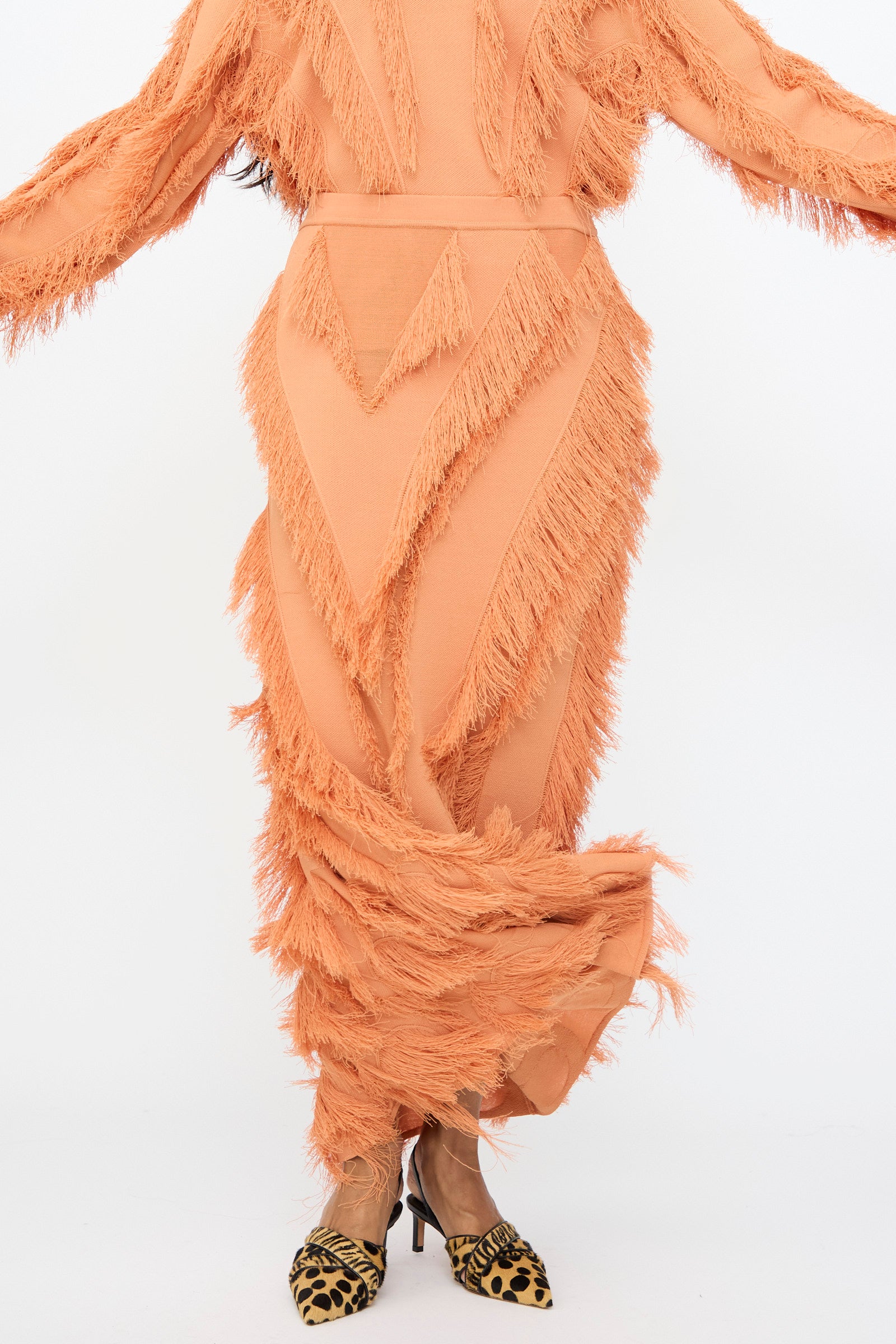 Model wearing the Astrid Maxi Skirt in Tulip by Ulla Johnson, arms partially outstretched, standing against a plain white background.