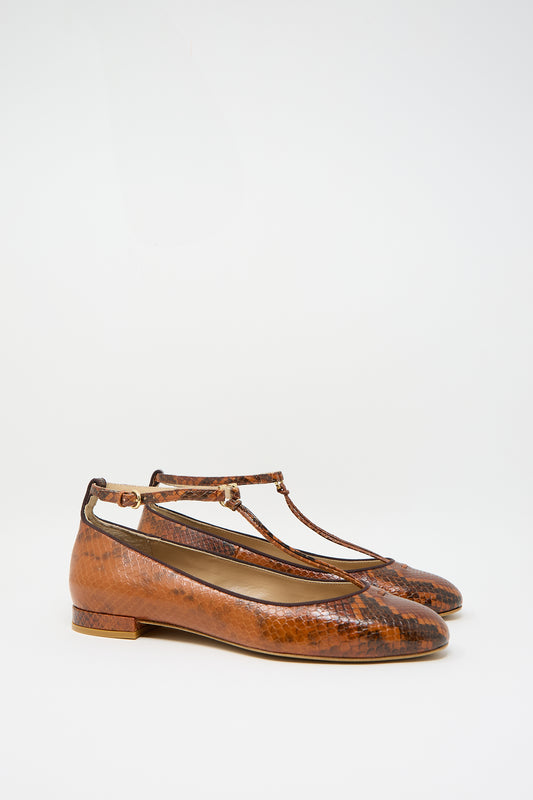 Pair of Mary Jane in Rust Copper by Ulla Johnson, featuring brown animal print leather with an adjustable ankle strap and low heels, displayed against a plain white background.