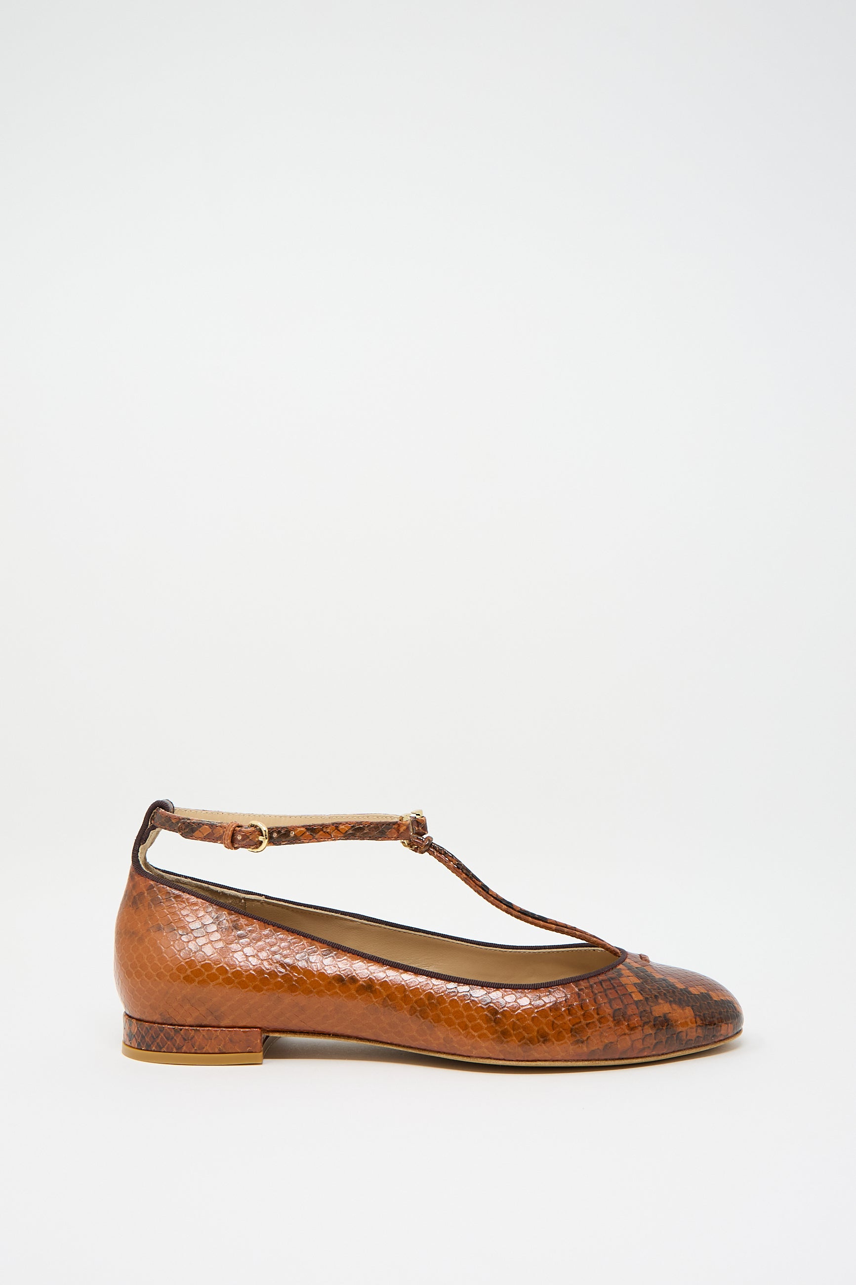 Rust copper snakeskin-patterned flat Mary Jane shoe from Ulla Johnson, featuring an adjustable ankle strap and T-bar design, placed against a plain white background.