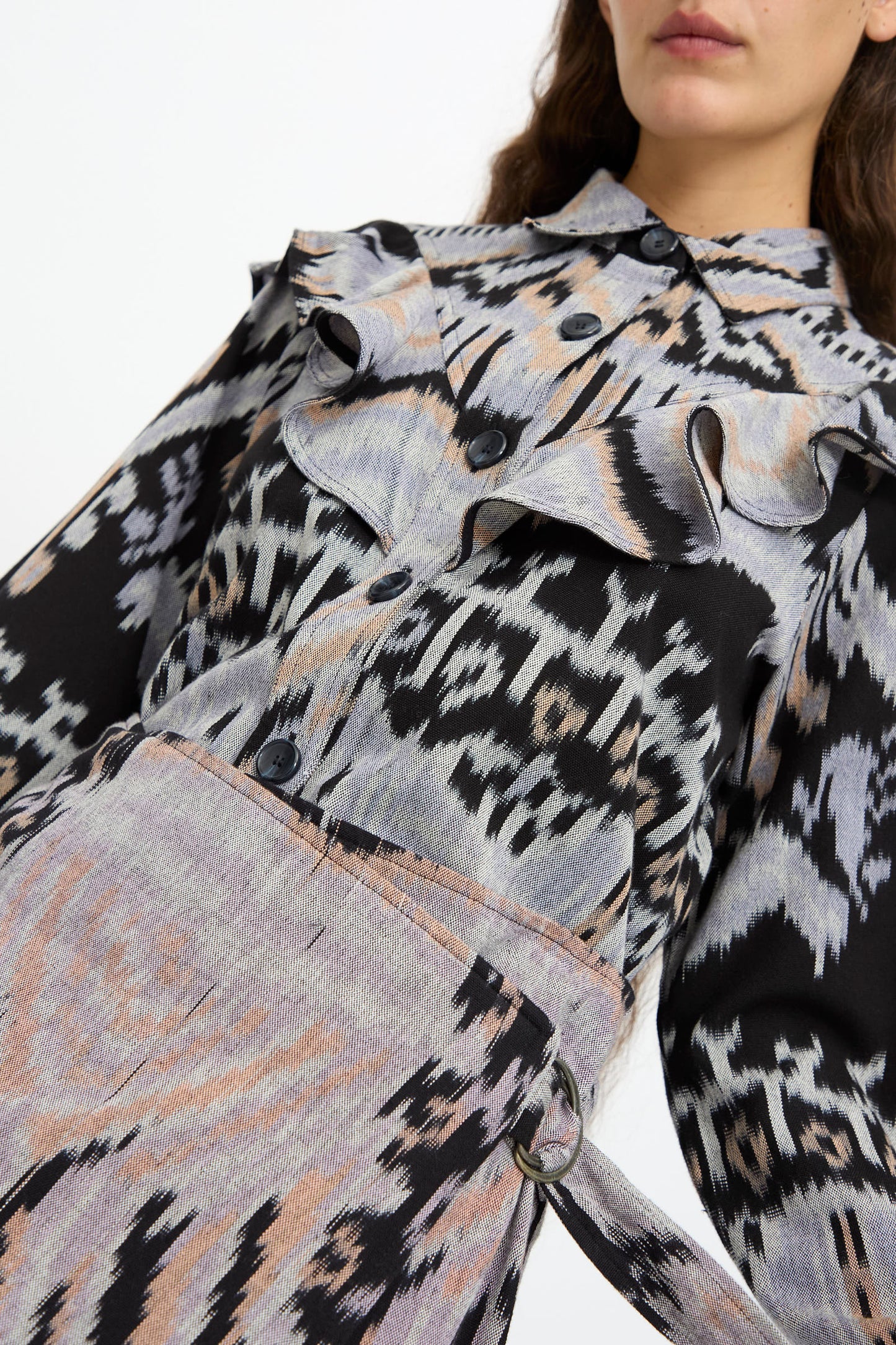 A woman wearing the Mila Pencil Skirt in Tigereye by Ulla Johnson, featuring grey, black, and peach abstract ikat patterns for a chic, modern look.