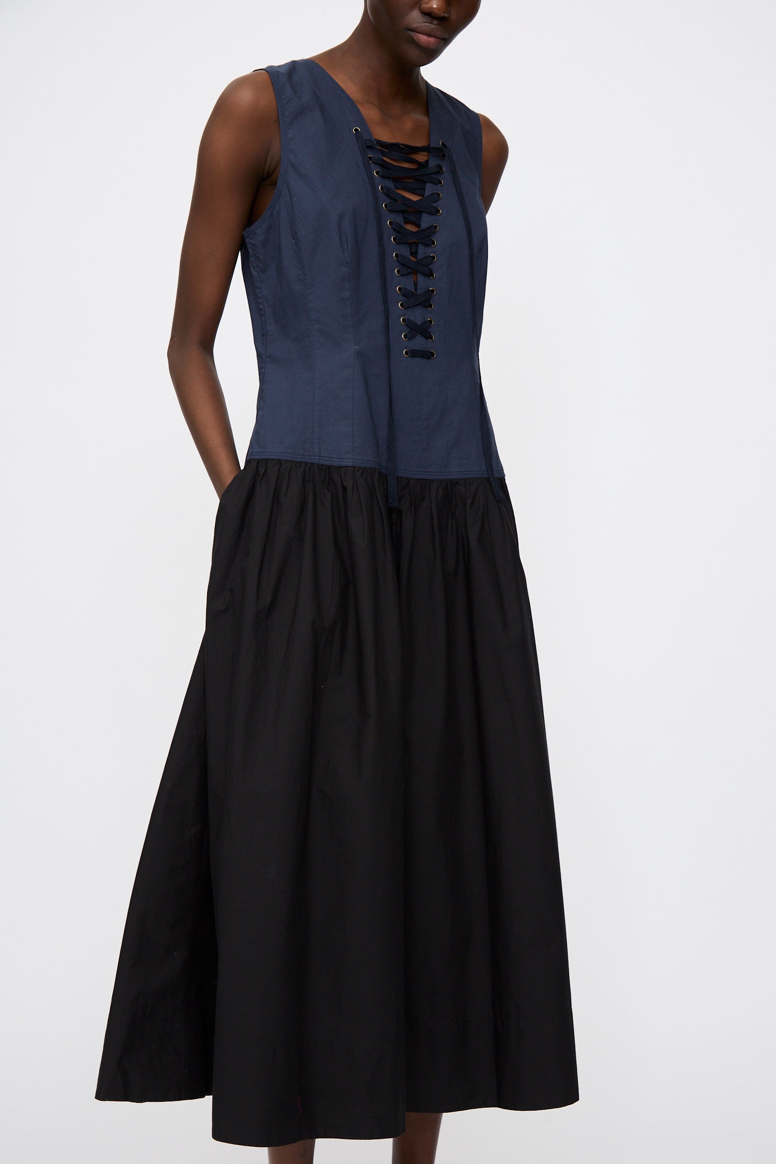 A person wearing the Ulla Johnson Water Washed Poplin Denia Dress in Twilight Colorblock stands against a plain light background.