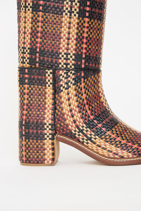 A close-up of a multicolored, knee-high Elena Woven Riding Boot in Brown with a wooden heel by Ulla Johnson.