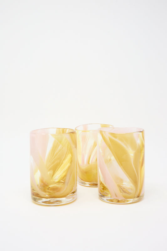 Three empty amber-toned Upstate Frankie Cups with a twisted design on a white background.