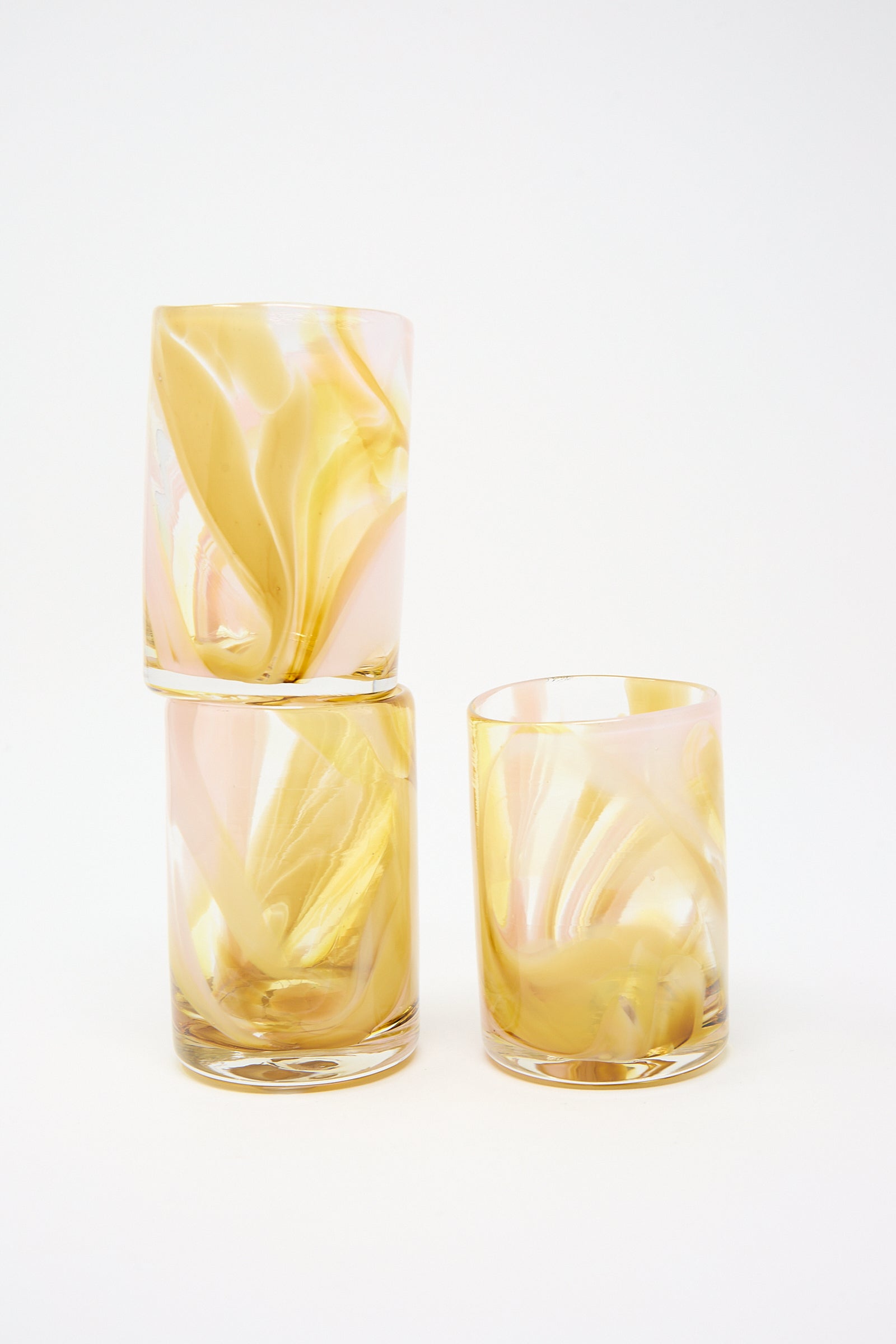 Two Frankie Cup hand blown glass tumblers, one stacked on top of the other, against a white background. Brand Name: Upstate