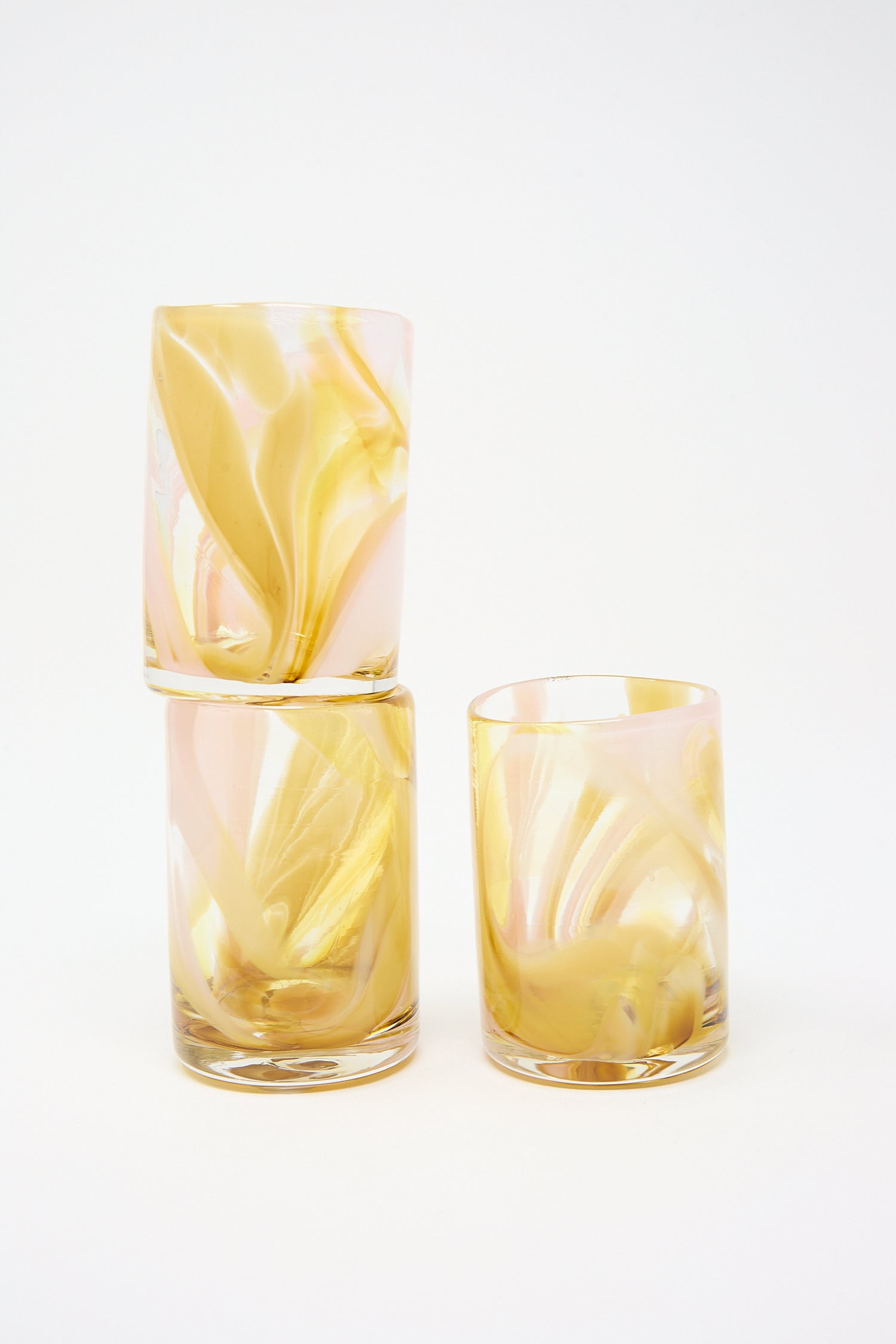 Two Frankie Cup hand blown glass tumblers, one stacked on top of the other, against a white background. Brand Name: Upstate