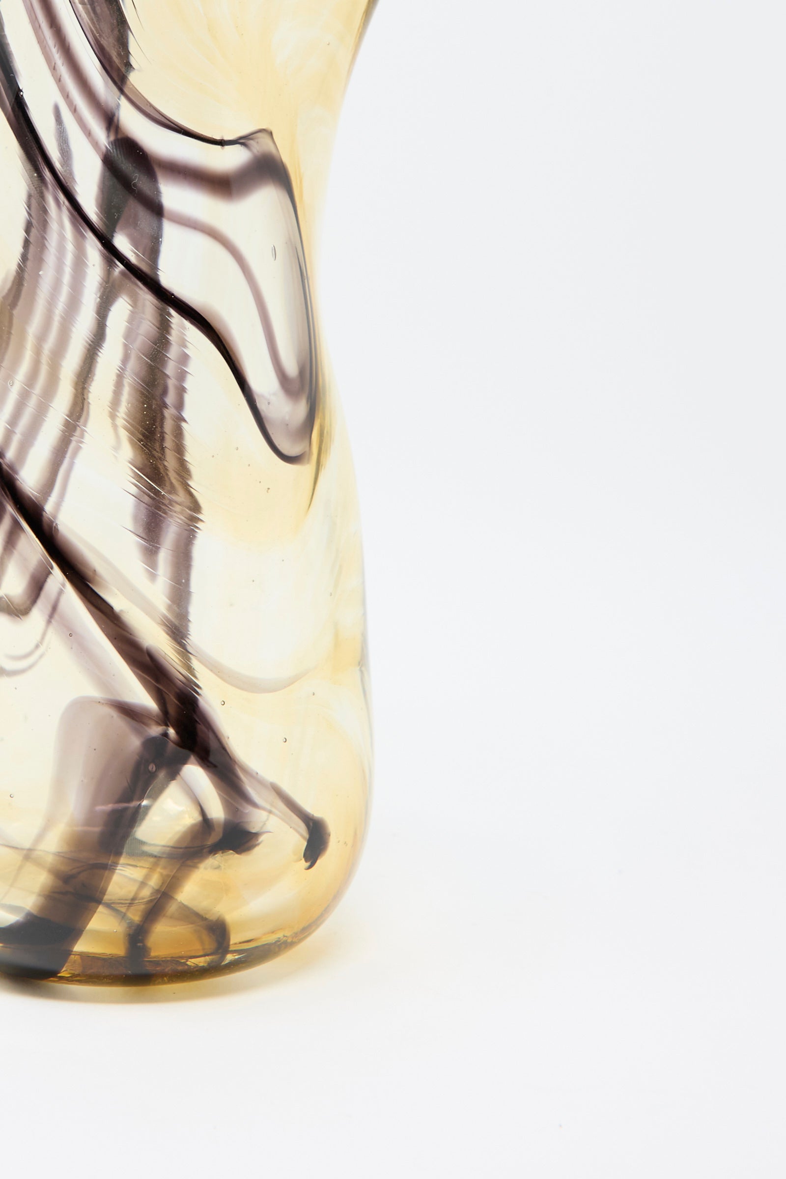 Close-up of the Hand Blown Fumé Carafe in Smoke and Tobacco by Upstate, featuring swirling smoke and tobacco patterns on a beige background.