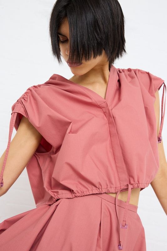 Woman wearing a pink Veronique Leroy Cotton Poplin Gathered Top in Canyon with adjustable ruche detail and drawstrings.