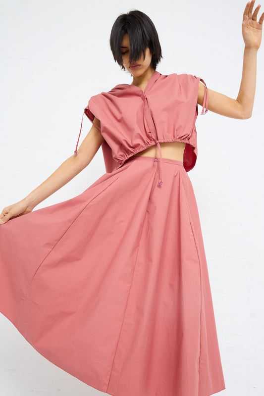 Woman in a pink, Veronique Leroy Cotton Poplin Skirt in Canyon posing with movement.