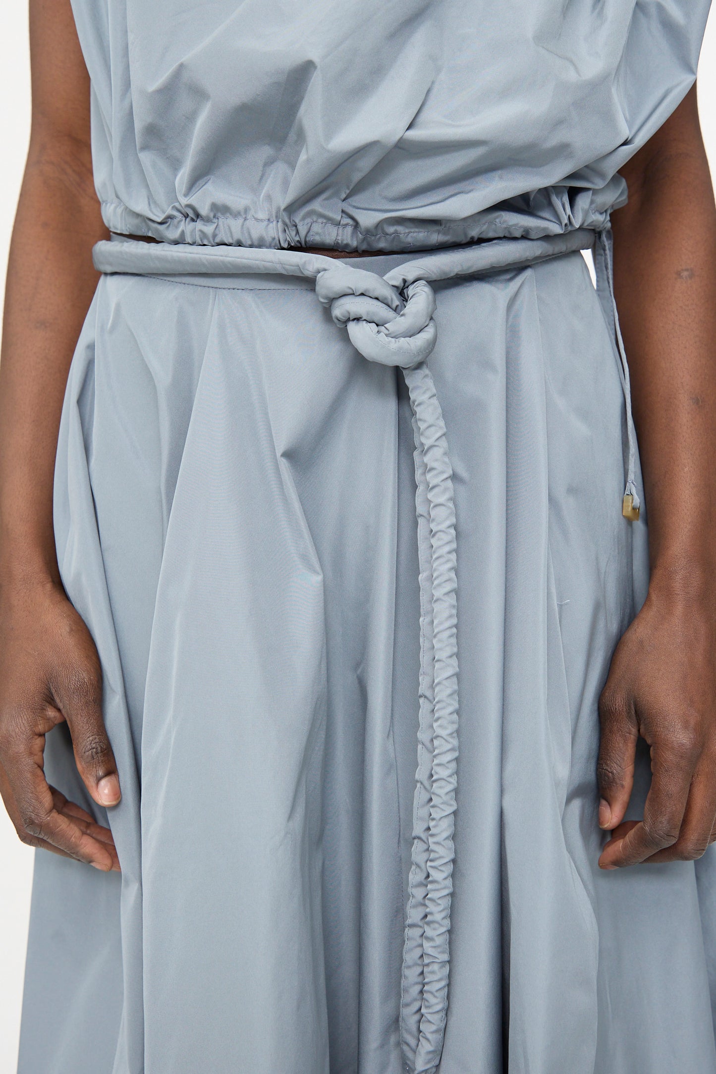 Person wearing the Veronique Leroy Taffeta Skirt in Storm, shown from mid-torso to hands.