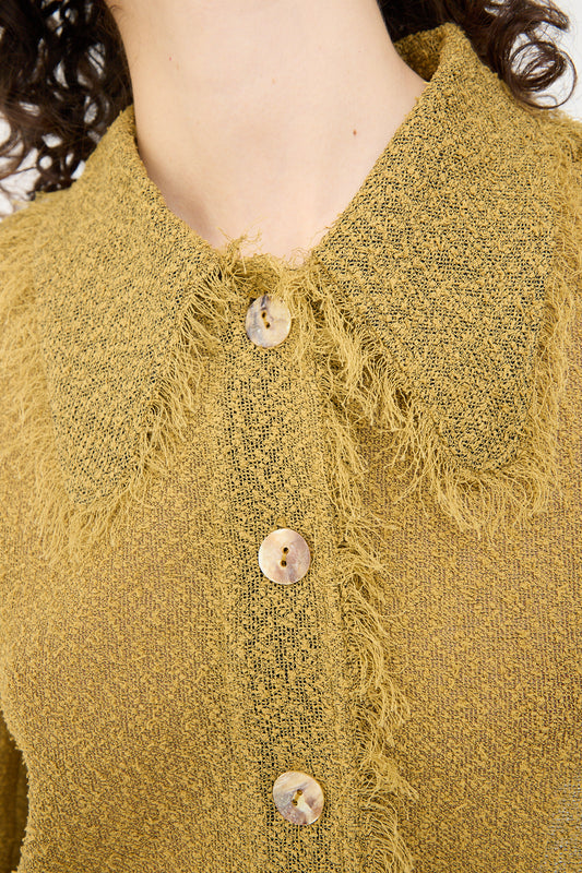 A close up of a woman wearing a Tweed Blouse in Cumin by Veronique Leroy.