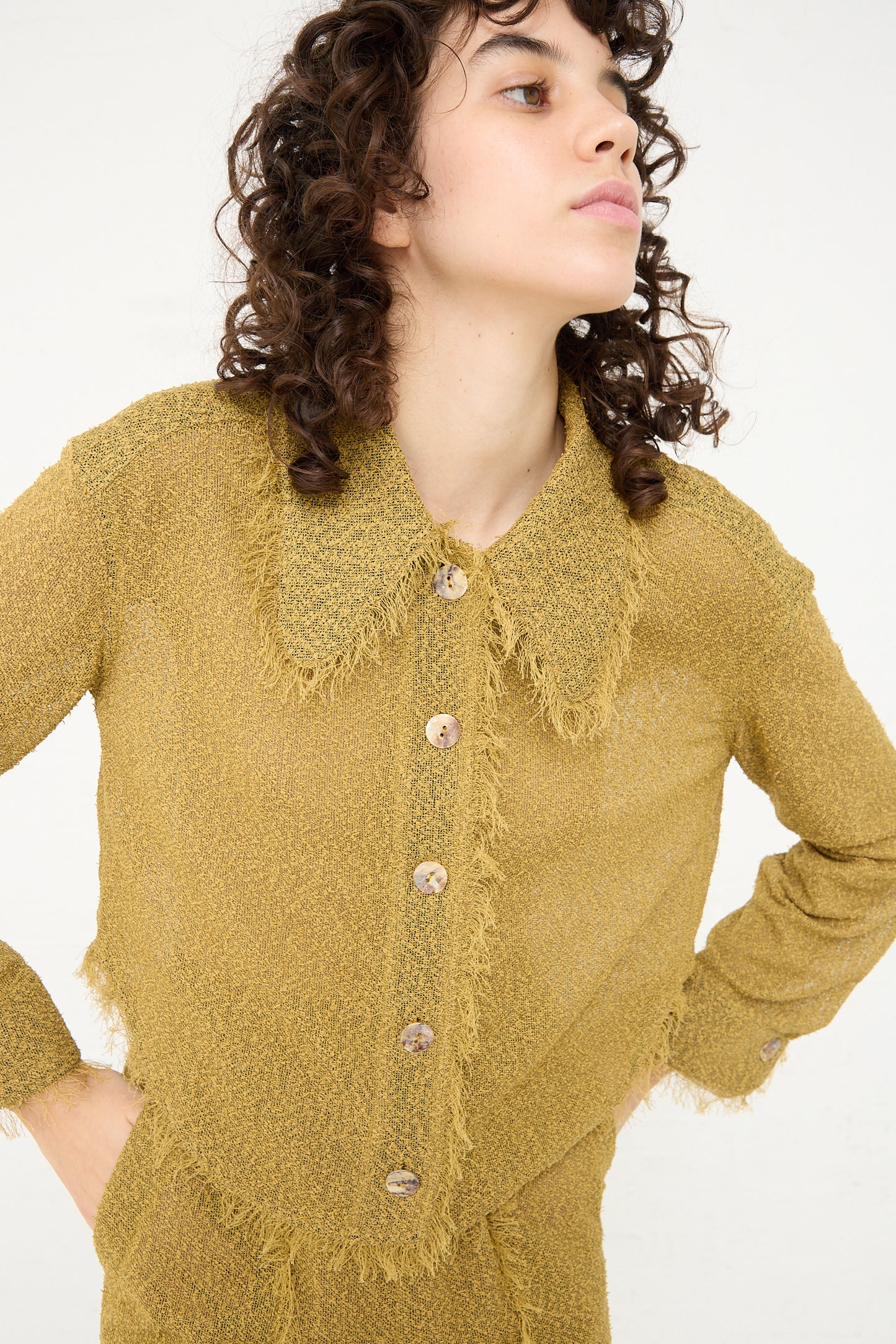 A woman wearing a lightweight, Tweed Blouse in Cumin and pants by Veronique Leroy.