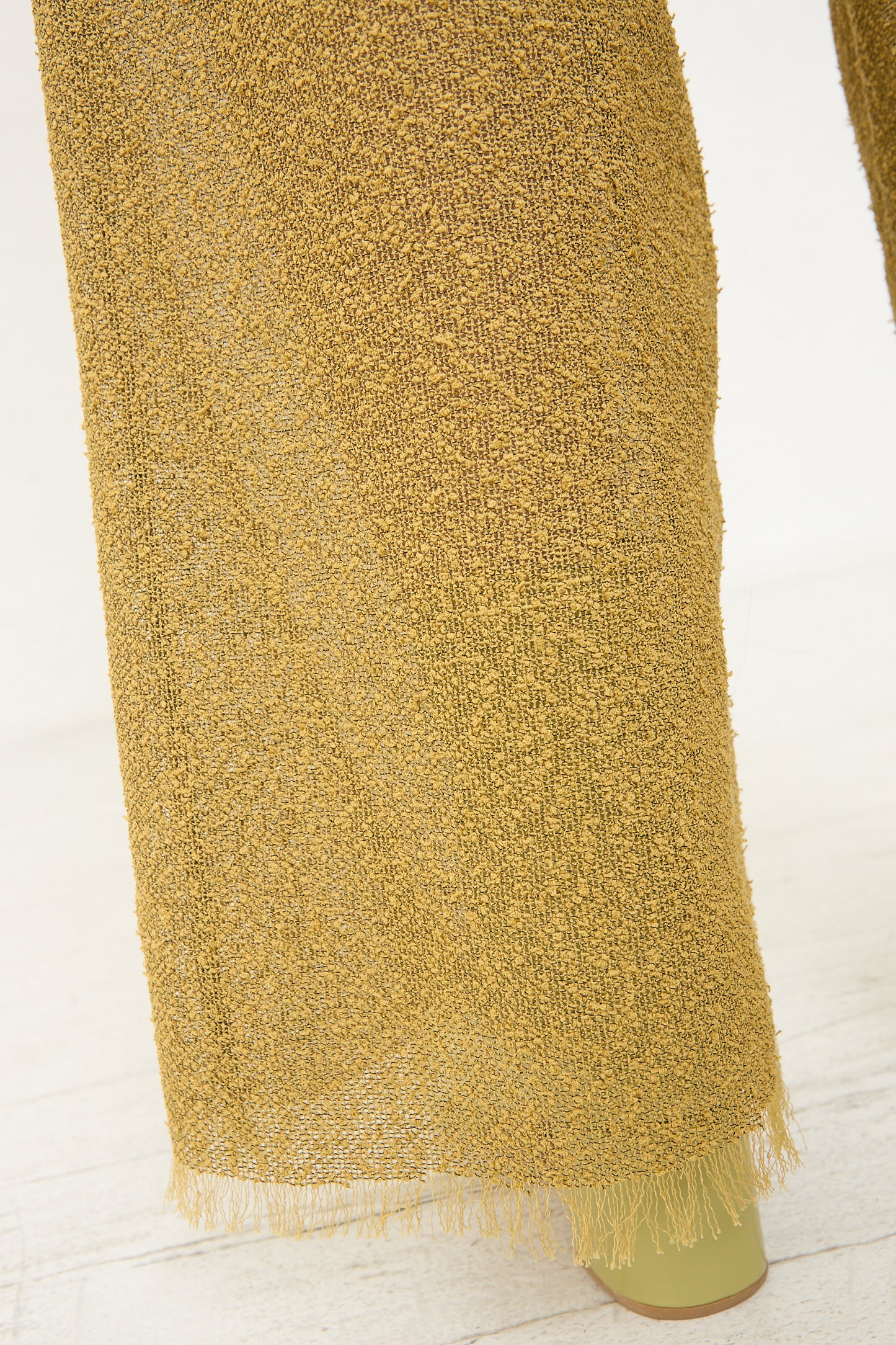 The back of a woman wearing Veronique Leroy's Tweed Frayed Trouser in Cumin.