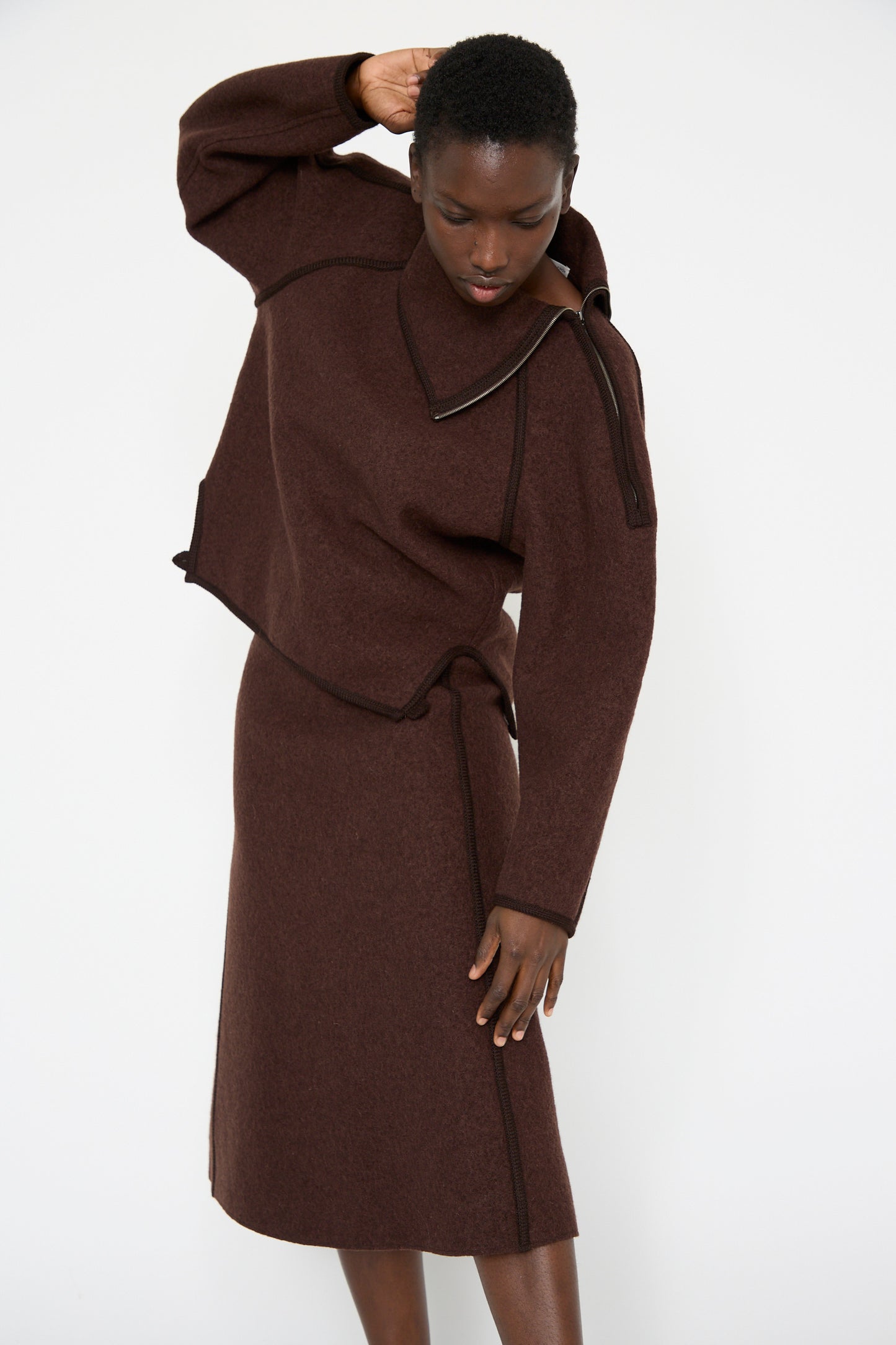 A woman wearing the Wool Long Skirt in Choco by Veronique Leroy, against a plain background.